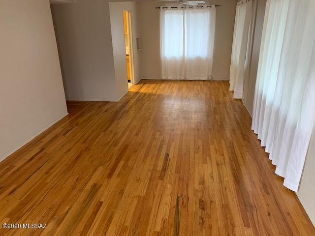 Sam Hughes 1057 sq. ft. vintage home with hardwood floors throughout is in great neighborhood just 2 short blocks to the university. Updated kitchen with newer appliances: gas stove, microwave, dishwasher & refrigerator. This duplex's laundry room has a washer & dryer with pantry storage. Newly refurbished tile bathroom & spacious bedrooms with walk-in closet. Separate dining room & living room looks out on the landscaped back yard. Private & fenced backyard with motion lighting & landscaped with Palo Verde & Mesquite trees for shade. Off street covered parking, and access to a storage room in a separate building at the back of the property that's perfect for your bikes and BBQ. Rent includes water, garbage, & gardener. New dual pane windows are installed for energy efficiency.