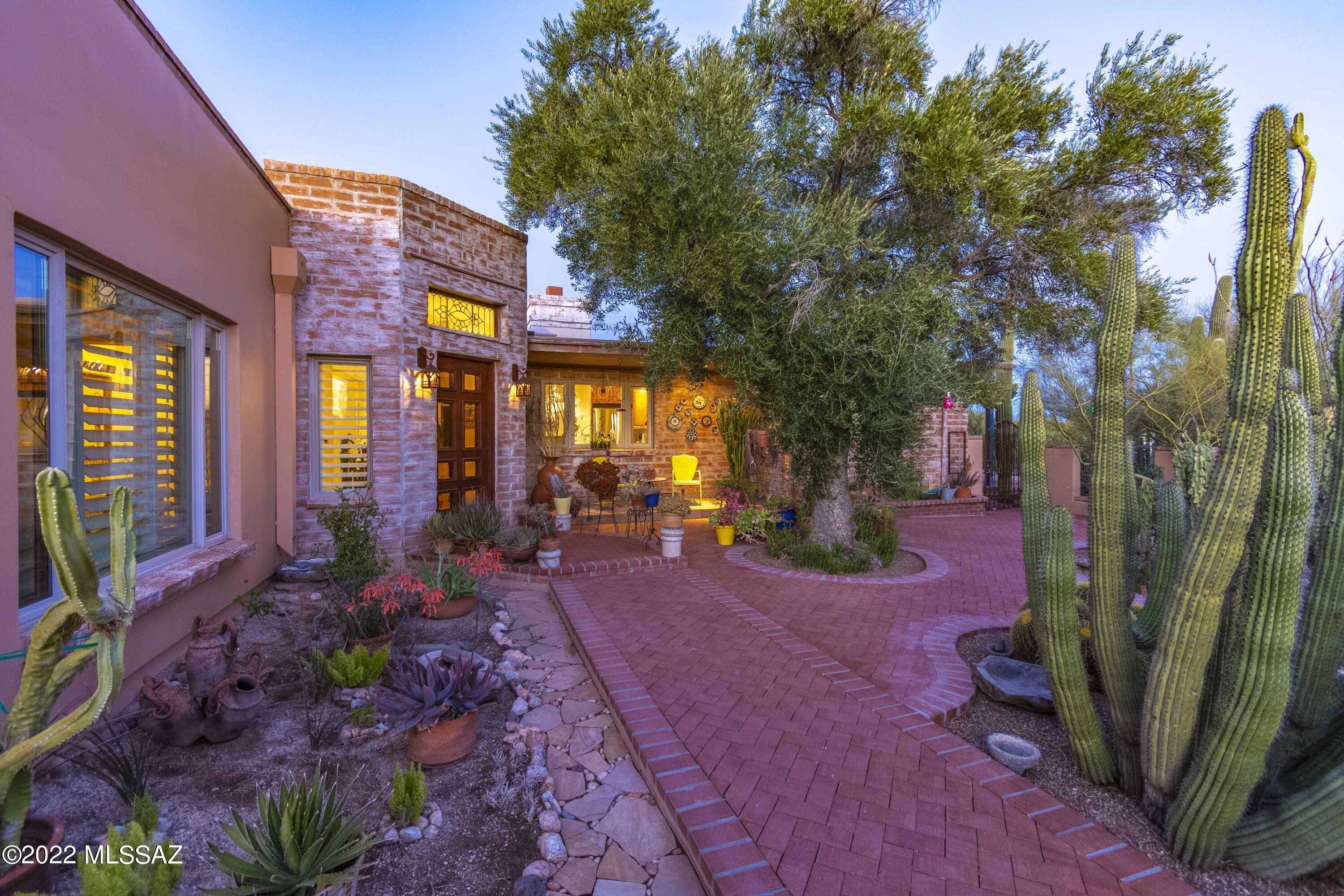Enjoy Beautiful Mountain VIEWS from almost every window! Located in coveted Casas Adobes Area. A Perfect Blend of Mid-Century Charm and Modern Function. Owners renovated the original burnt adobe  home & added a Luxurious Master Retreat.  Sited on a 1.37 acre rich with desert vegetation. A long aggregate driveway leads to custom wrought iron gate, into a space alive with lush landscaping & walkway to the custom front door. A huge window framing Pima Canyon graces the expansive Great Room. The Master Suite has His & Hers walk-in-closets. Master Bath offers custom vanities, marble shower (2 shower heads) towel warmer, air jet tub, Sauna, high-end granite & bath fixtures. Family room opens to the covered patio, while multiple windows bring-in the outdoors and the VIEWS! OWNER/AGENT Kitchen features granite counters, wood cabinets, prep sink, Dacor Oven, Fisher & Paykel gas cooktop and dishwasher. Adjacent to kitchen there is a space with plumbing, would be a perfect Butler's pantry. En-suite 2nd bedroom has sitting area, many windows and a Great View. Third bath just re-done. 760 sq. ft. garage has large workshop space, 2 storage areas. Other features include travertine & concrete floors, fireplace, plantation shutters. Citrus trees, raised vegetable garden. Burnt Adobe construction. This home is full of character and charm. No HOA plenty of room for a guesthouse, another garage. Huge windows overlook the Catalina Mountains. Located within close proximity to shopping and fine/casual dining, near Casas Adobes shopping Center.