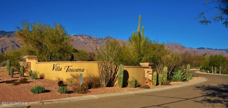 Outstanding Tuscan Style Home with Majestic Mountain Views in the desirable gated community VILLA TOSCANA. Luxury and Elegance are the inspiration for this incredible Estate. Dramatic soaring ceilings, formal dining room, upgraded lighting, custom interior palette, travertine floors, and wine cooler bar. Beautiful hardwood floors and plush neutral carpet in all the right places. Gorgeous gourmet kitchen features high-end SS appliances, large center island, granite counters, and custom wood cabinetry with stylish hardware. Architecturally pleasing to the eye.  Wood beamed ceilings, large windows, stone fireplace, Arcadia Doors to patio, art niches, media alcove, and upscale bathrooms with designer tile, granite, cabinetry, and lighting. Perfect Home for entertaining inside and out... Extended covered paver patio, refreshing pool w/water features, spa,  view fence of Mountains and natural desert.  Built-in BBQ/kitchenette area.  This unique and detailed home is a must see!