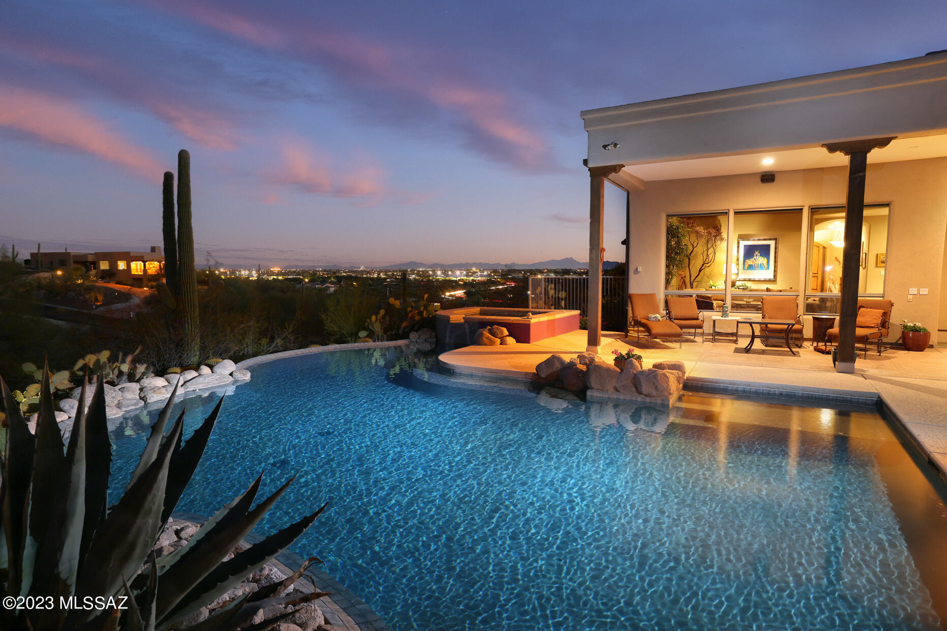 Breathtaking Top of the World views from this incredible custom Reggie Amos built Hilltop property. Wind your way up to this 3 Bedroom, 3 Bath + Den, Gated Foothills Gem. Home has been recently updated with a gorgeous new kitchen featuring stunning Canyon Cabinetry with Wolf, Miele and Liebherr appliances & luxurious Ceasarstone counters. Beautiful Turkish travertine floors throughout except bedrooms. Amazing custom Anasazi pool and spa look directly to a full unobstructed view of the Catalina Mountains and the City! Fire-pit, surrounded by a flagstone viewing deck and built in BBQ with seating make for a  wonderful outdoor entertaining space! Oversized 3 car garage with 2 storage rooms. This is a warm and inviting home.