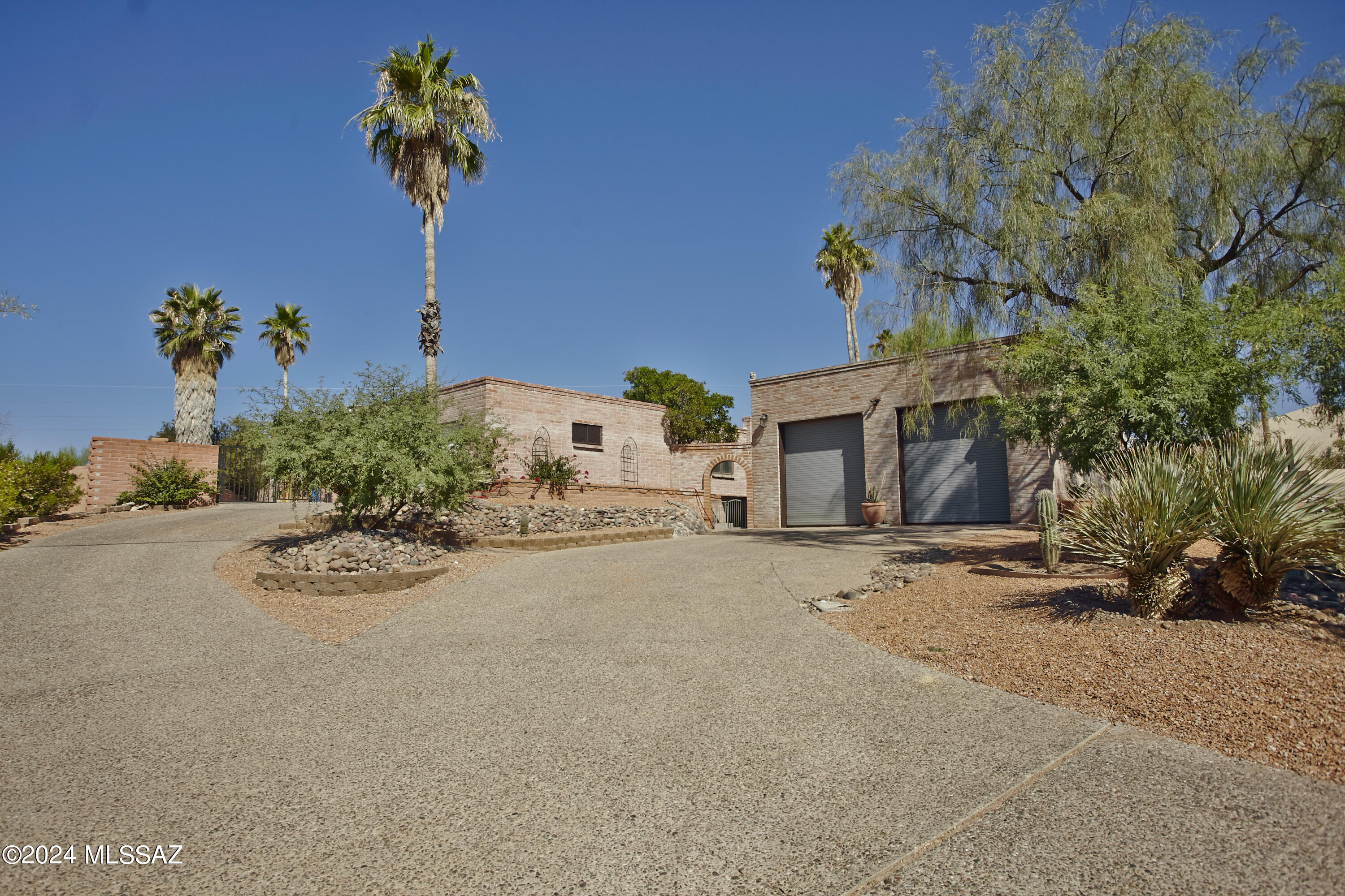 This home exudes Southwestern charm with its rich, warm tones and distinctive features. The floors are adorned with traditional Saltillo tiles, their earthy, terracotta hues adding a rustic, handcrafted feel. 
New remodeled kitchen/family rooms created a wonderful warm open floorplan. Kraft made quartz counters, ss appliances.. One br, has Murphy bed & separate sitting area, perfect for generational living or office.The dining room w/fireplace. Step outside the expansive yard with pool/spa, & extended yard that could be used for so many things, basketball, volleyball, pickleball court. 2 RV size garage is a workshop dream! Has its own a/c, air compressor, wire for high powered tools. Plenty of storage, storage room accessed from back yard, 
Cabinets in garage, in RV there are shelves for upper storage. ladder to access them will convey. Spa is currently not heated and will be sold as is.