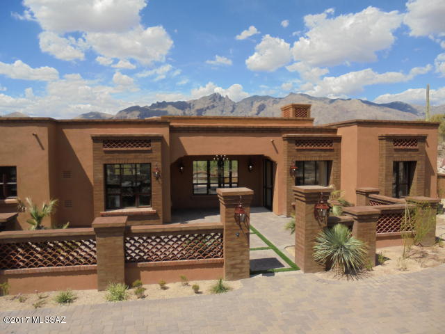 New Construction in Old Foothills on Large Secluded lot in Private Gated Community. Perfect blend of modern & Hacienda charm. Great Room features, Beamed Ceilings w/Hand Carved Corbels, Hand Plastered Fireplace & Travertine Floors. Floor to ceiling Steel Sash Windows open to Sensational Mountain Views. Top of the line Thermadore Appliances and a Large Granite island. Lot backs up to Natural Riparian Area.