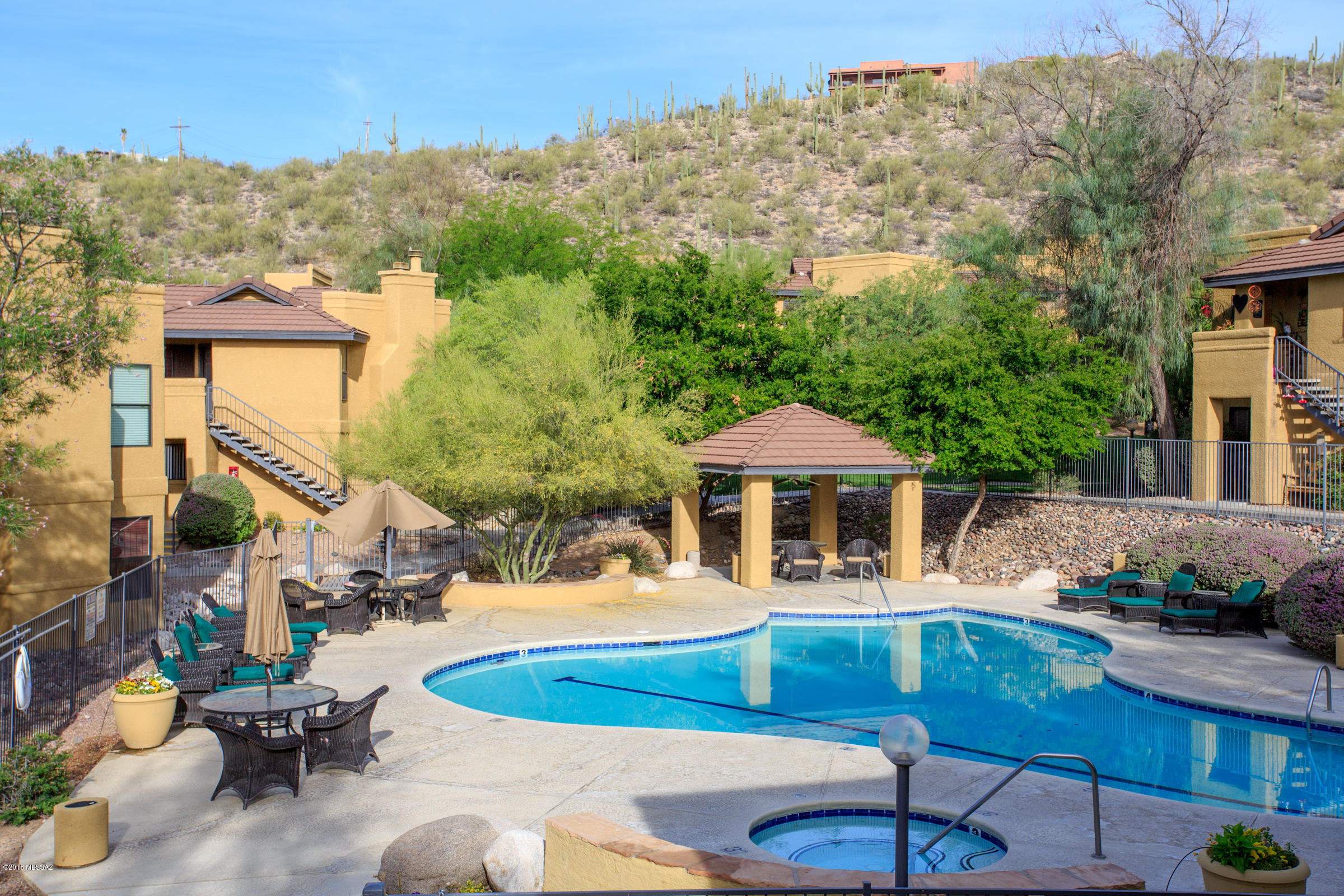 Ground floor condo overlooking community pool & park-like grounds in the gated resort style subdivision of The Villas At Sabino Canyon. Includes pool, spa & work out room. Lovely  & completely updated 2 bed/ 2 full bath. Kitchen includes pretty corian counters, stainless appliances lots of cabinets & a pantry. 20'' tile & newer carpet (only in bedrooms). Lots of privacy & green view from covered patio. No steps! Wide hallways & doorways. Large bedrooms & baths. Walk in closet. Great storage. Well laid out split plan. This is a barely used home. Neutral colors. All appliances stay inc. fridge, washer & dryer. Covered parking for 1 car.  Lots of extra parking near unit. HOA covers garbage, water, roof, ext. pest control. Good size storage room. 
BRAND NEW HVAC!