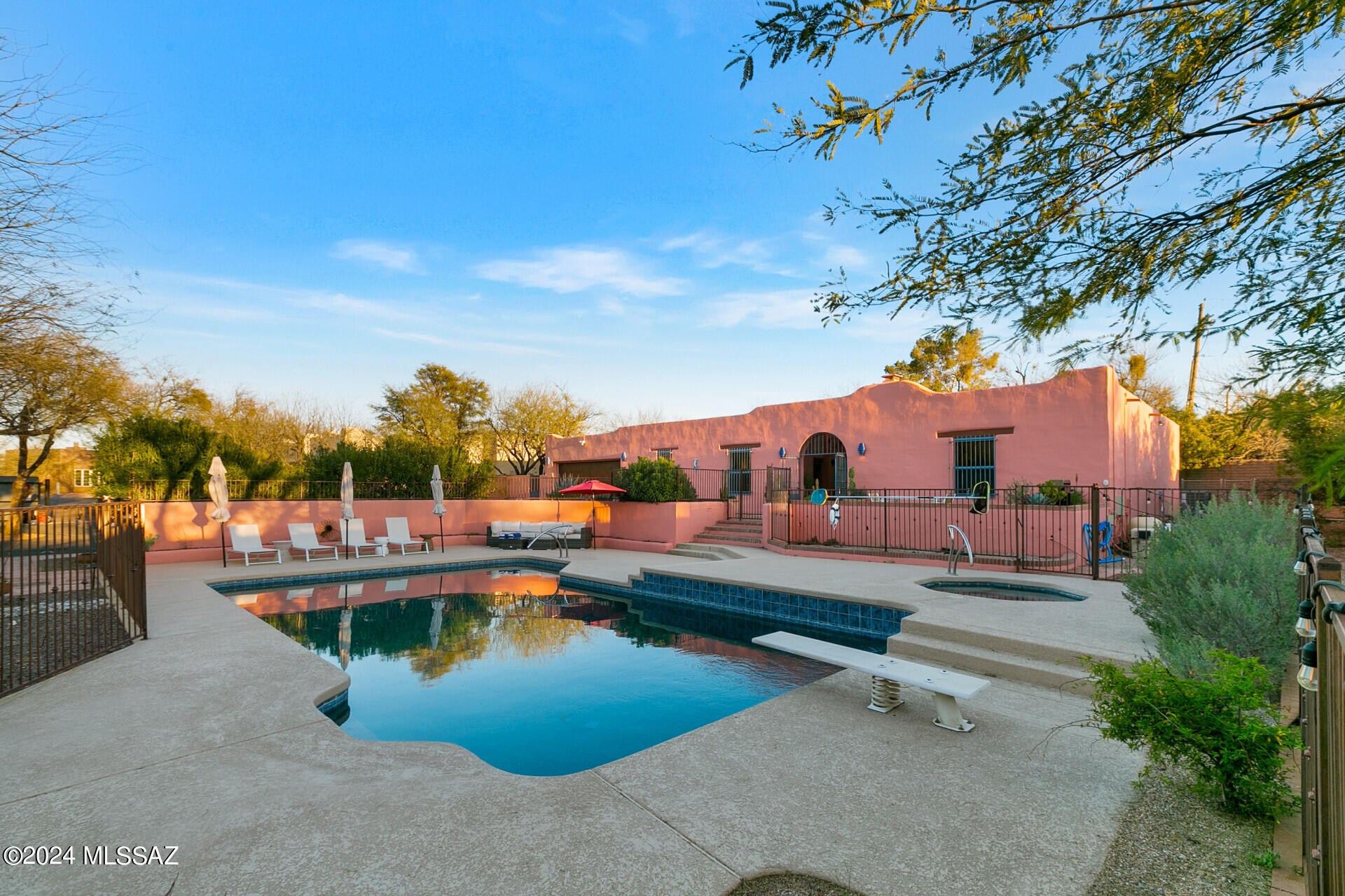 Welcome to the Casa Rosada home! This 4-bedroom, 3 full bath home includes a main home (3-bed / 2 bath) and separate detached guest home (1 bed / 1 bath / full kitchen. This property is presently operated as a popular short-term vacation rental and can be purchased as a turn-key investment property or as a primary residence for you to call home. Authentic Mud Adobe home located in a mesquite forest in Tucson's desirable Fort Lowell Historic District. Meticulously hand-built using craftsman techniques and materials. Large foyer with soaring and unique sahuaro rib ceiling. Charming mix of brick and Saltillo tile. Large swimming pool and hot tub with Pentair automation. Newer high efficiency gas/electric hybrid AC/Heater units. Private gated entrance.  This is truly a southwest gem.