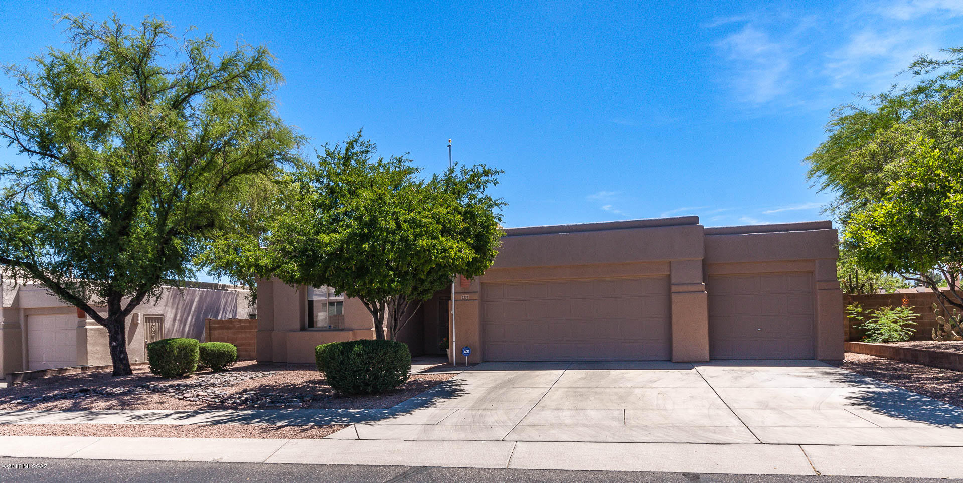 Charming home in gated community of Ranchp Esperero just north of Udall Park. Large perimeter lot with views and no neighbors to the east. With 3 car garage and 3 car flat parking in driveway. Builder's largest model - 1,882 sq ft with 3 bedrooms plus a den. Features a great room with high ceilings, a plit bedroom design, and two full baths. Three community pools, spas, and ramadas; plenty of common area throughout complex.