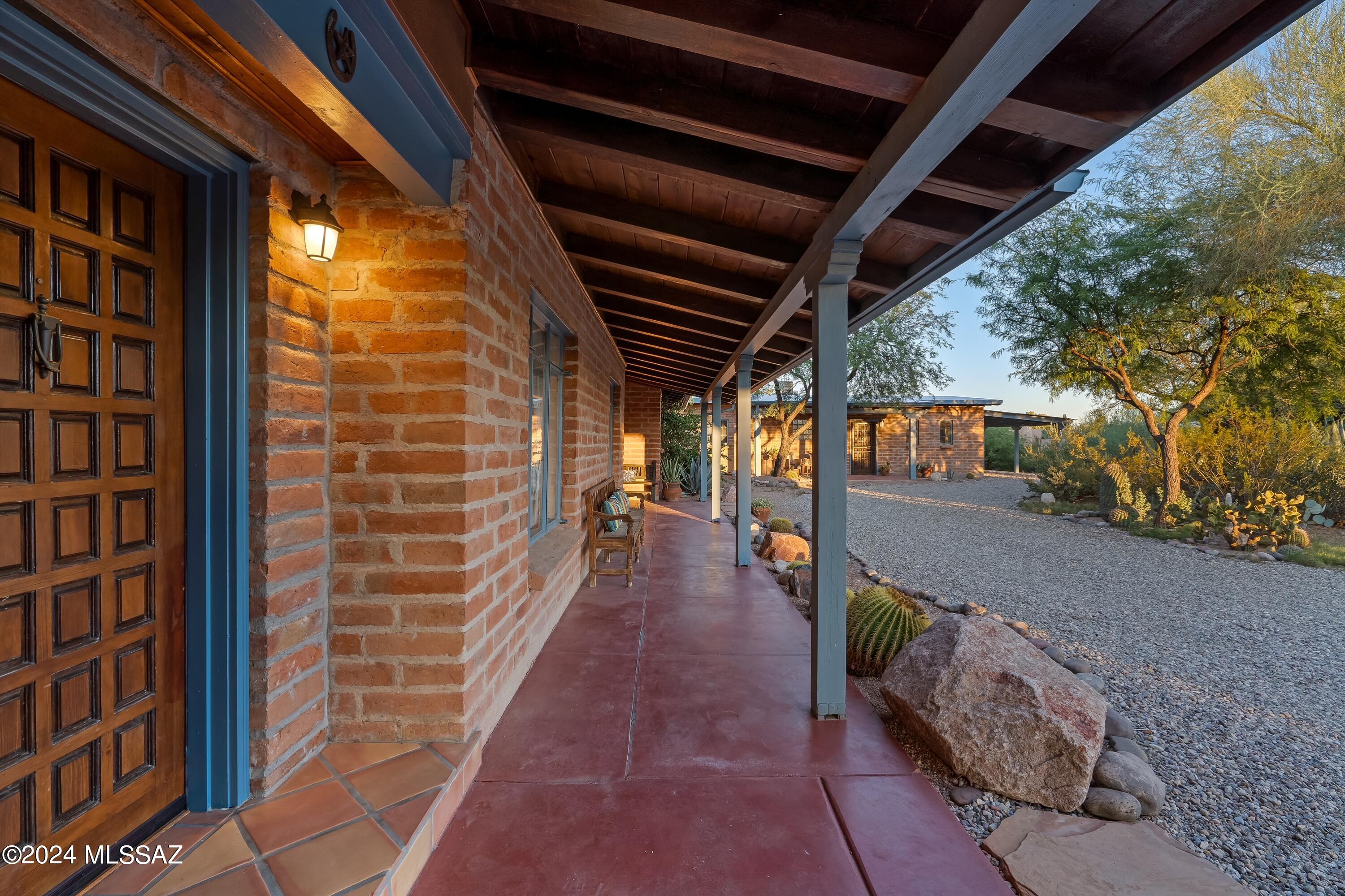 Seller is accepting back-up offers. Set against a spectacular panorama of the Catalina Mountains, this sprawling adobe ranch has been meticulously maintained for decades. An intimate collection of structures and spaces make this an incredibly rare opportunity. Akin to the classic hospitality properties of Tucson's famous Tanque Verde Guest Ranch, this residence has been home to artists and writers who found inspiration in its mature desert surroundings and tranquil environments. Both rustic and elegant, the interiors of the main home and two guest casitas are rich with organic and thoughtful details. Few properties of this scale offer such a superb balance of character, amenities, and practicality, all just a short distance to the Loop, Tucson Medical Center, and Historic Ft. Lowell Park.