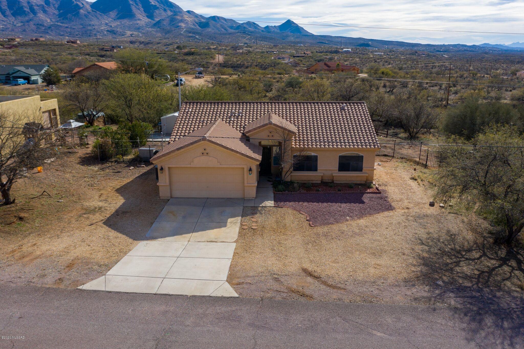 New kitchen cabinets, with new Samsung electric stove, and over the range oven. New master bathroom vanities with custom cabinets in master closet. Large sliding door that leads to covered patio and beautiful desert landscaped yard for entertaining and enjoying the mountain views. This house has many more upgrades throughout you don't want to miss! Living is easy in this impressive and immaculate home located in a beautiful, small and peaceful neighborhood with quick and easy access to I-19 interstate.