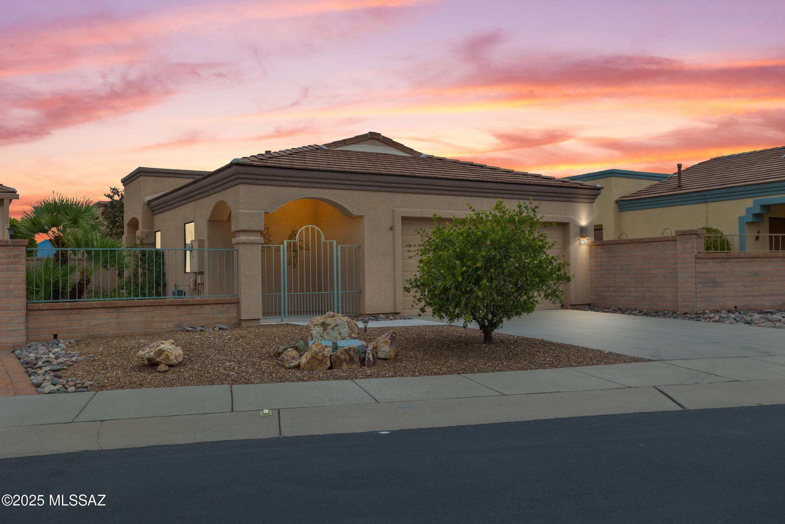 Incredible home with spectacular Santa Rita Mountain Panoramic VIEWS! Enjoy your morning coffee and relax on your covered bricked east facing patio looking to your manicured landscaping while gazing at the warm colors of Madera Canyon. With a gated courtyard in the front of the home for security and convenience. Upon entering you'll find light filled main living areas that capture mountain views from every window. Enjoy meals with friends in separate dining area that adjoins Great Room. Bedrooms are spacious with ample storage. NO POLY! Plumbing re-piped 2025. In addition to 2 parking spaces, the garage includes golf cart parking, workshop space, and epoxy flooring. Other home improvements include upgraded flooring, sun-shades throughout, new fixtures, and fresh new paint! Located near 2 golf courses, 2 recreation centers and restaurants. This delightful turn-key move-in ready home is ready to enjoy!