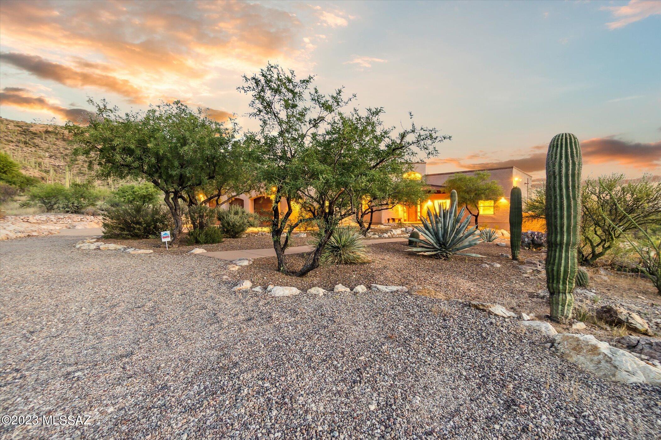 Stunning Southwest contemporary home on a large 3.3 acre lot. This 5 BD/3 ½ BA/3,170 Sq.Ft home has an inviting floorplan w/open concept great room off kitchen w/ custom built-in entertainment center & wood beams & formal dining room w/private patio. Gourmet kitchen offers granite counters, Cherry cabinets, Kitchen Aide stainless steel appliances, island w/wine fridge & breakfast bar & walk-in pantry. Concrete floors throughout the home (no carpet), high ceilings, solid alder wood doors, walls of windows & door that let in plenty of natural light & 7'' baseboards in most rooms are a few of the features of this exceptional property. Primary suite offers French doors to patio, remodeled bathroom w/granite counters, dual vanity/cherry wood cabinets, separate garden tub & walk-in shower...... .....& large walk-in closet. Backyard has a covered patio to enjoy the views, built-in BBQ, wood burning fireplace, pebble-tec pool/spa w/solar heating & propane & large sideyard. 3 car garage w/built-in storage & additional heated/cooled workshop or exercise room.