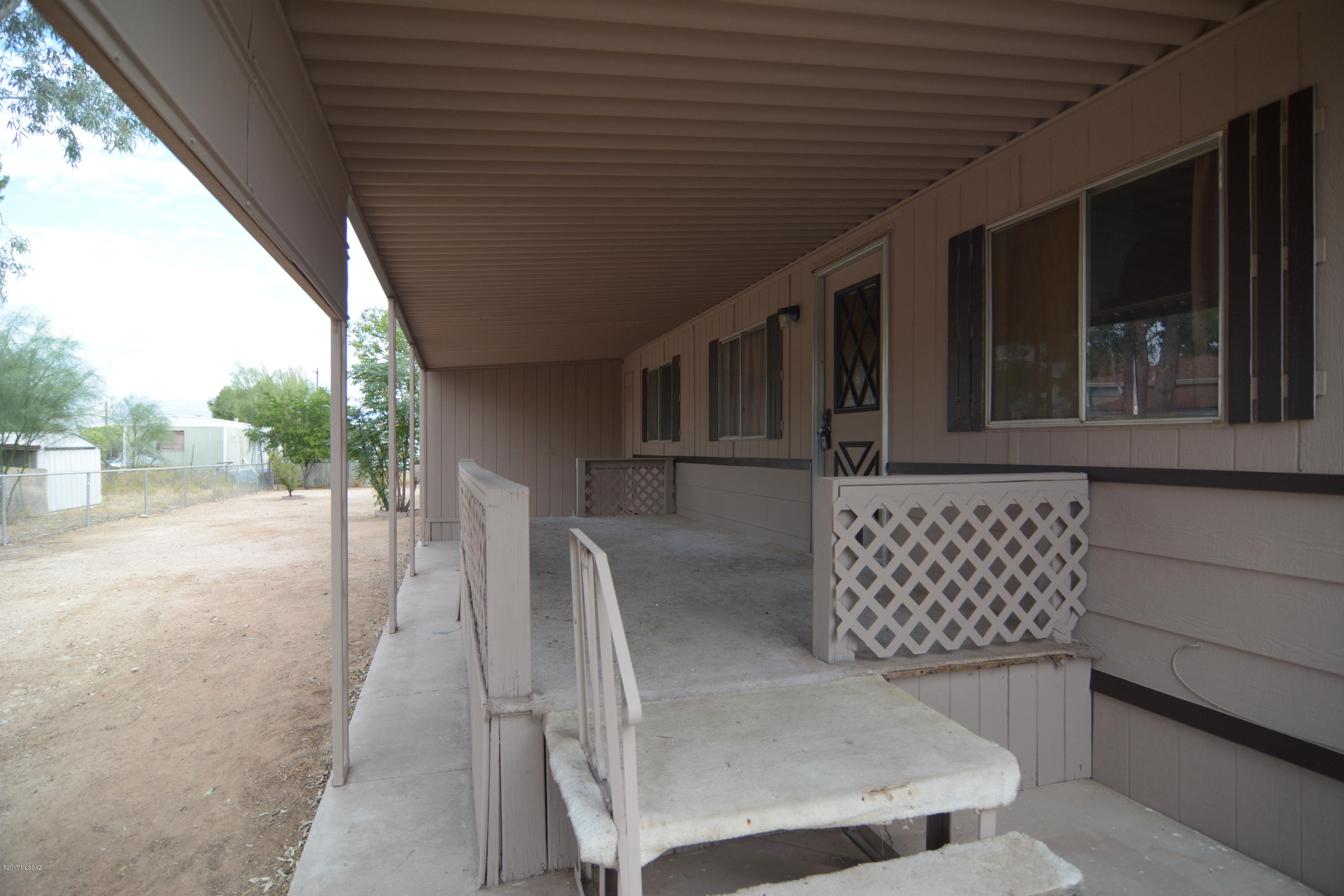 Enjoy desert living in this beautiful home. New exterior paint. Great living space. A wonderful living room with light filled living. Newer carpet and padding in bedrooms and living areas. Fully fenced large yard. On nice parcel of MU land. Lots of mature vegetation. This home is really special.