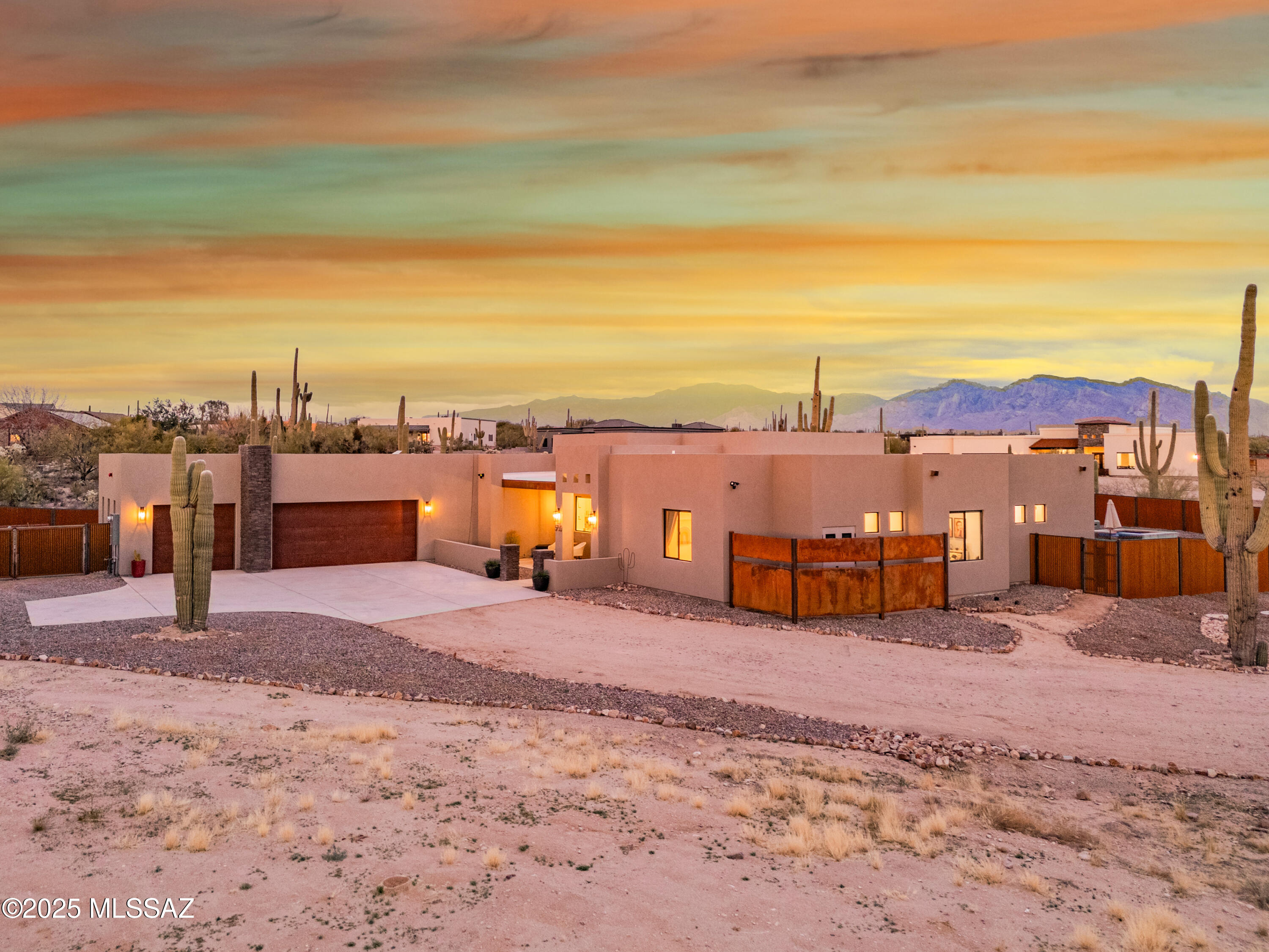 This beautiful, 2023 custom home sits on a 1.8-acre saguaro-studded lot, offering breathtaking sunrise and sunset views. This well planned design offers a split-bedroom floor plan and features a luxurious master suite, with spa-like amenities, a second master suite, open and bright kitchen, wet bar with wine fridge, and large pantry. The oversized three-car garage includes an attached workshop with ample space for storage. Step outside to the private backyard oasis, complete with an expansive covered patio, artificial turf lawn, play set for the kids, and a stunning pool with cascading spa. This incredible yard is enclosed by a corrugated metal fence and allows additional space for expansion. With no HOA, there's plenty of room for all your toys! Schedule your private showing today!