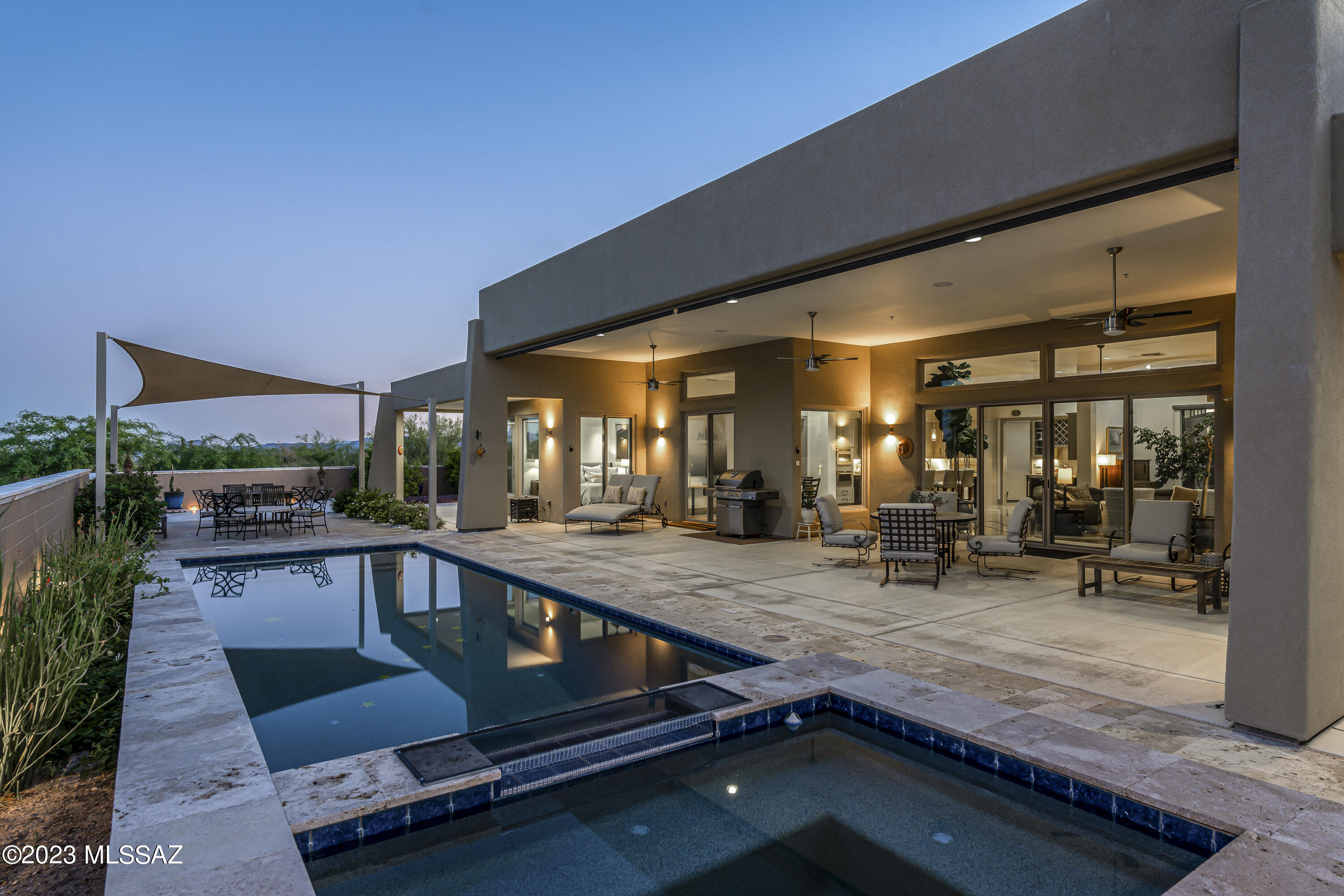 You will be greeted by Iron Double Entry Doors of this 2017 Custom-Built Estate on 3.3 acres in desirable Oro Valley. 11 ft. ceilings & energy efficient lighting create an airy feel. The glass gas FP & gourmet kitchen with Jenn Air appliances, steam oven, wine cooler, wet bar & butler pantry, awaits. 2 east-facing masters with huge closets, rainwater shower heads, dual vanities & a free-standing tub. Enjoy separate 3rd bed with hall bath & extended closet. Breathtaking Catalina views & desert landscapes from the back patio with roll-down screens, travertine pavers,heated pool & jetted spa. Tortolita & Tucson ranges in front delight. Garage with 10x10 RV space, epoxy floor & air compressor. Unwind to desert sounds & wildlife. Enjoy desert blooms & strolls on aptly named Desert Splendor Ct.