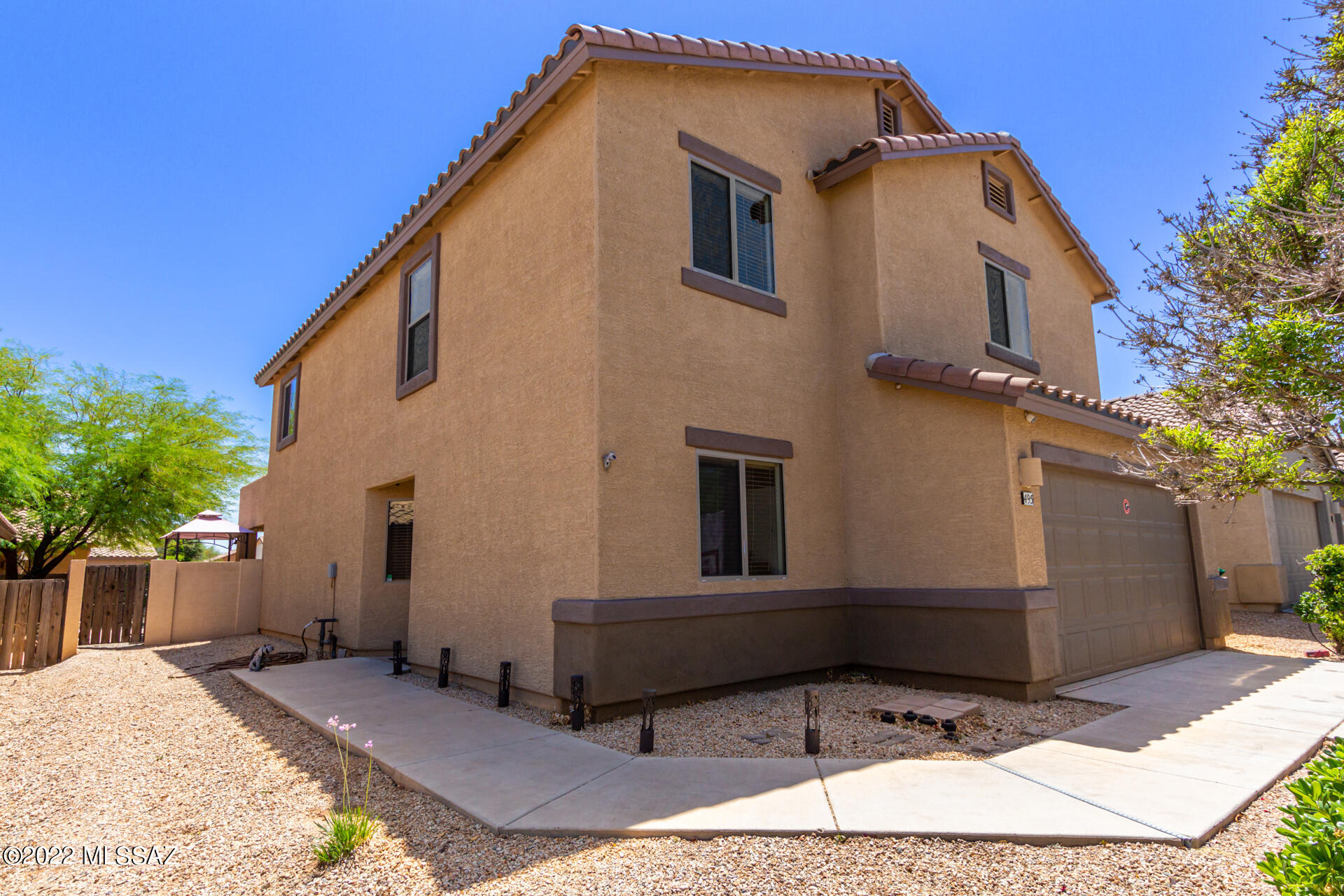 This beautiful two-story home located in award-winning Rancho Sahuarita is a must-see! It has 4 bedrooms, 3 full bathrooms, plus a large loft upstairs that would be perfect for a home gym or family movie nights.
The bonus room downstairs is just steps from the front door and would make a great home office, or maybe it's your next man cave or craft room. The great room, right off the dining room and kitchen, is open and inviting. While the breakfast bar and kitchen offer plenty of counter space for Saturday brunch or an afternoon of cookie decorating. 
Don't miss the large landscaped back yard with overhead misters, pavers, decorative rock, rose bushes, citrus trees and more. It's the perfect oasis to stop and smell the roses, or entertain family and friends all year long. Welcome home!