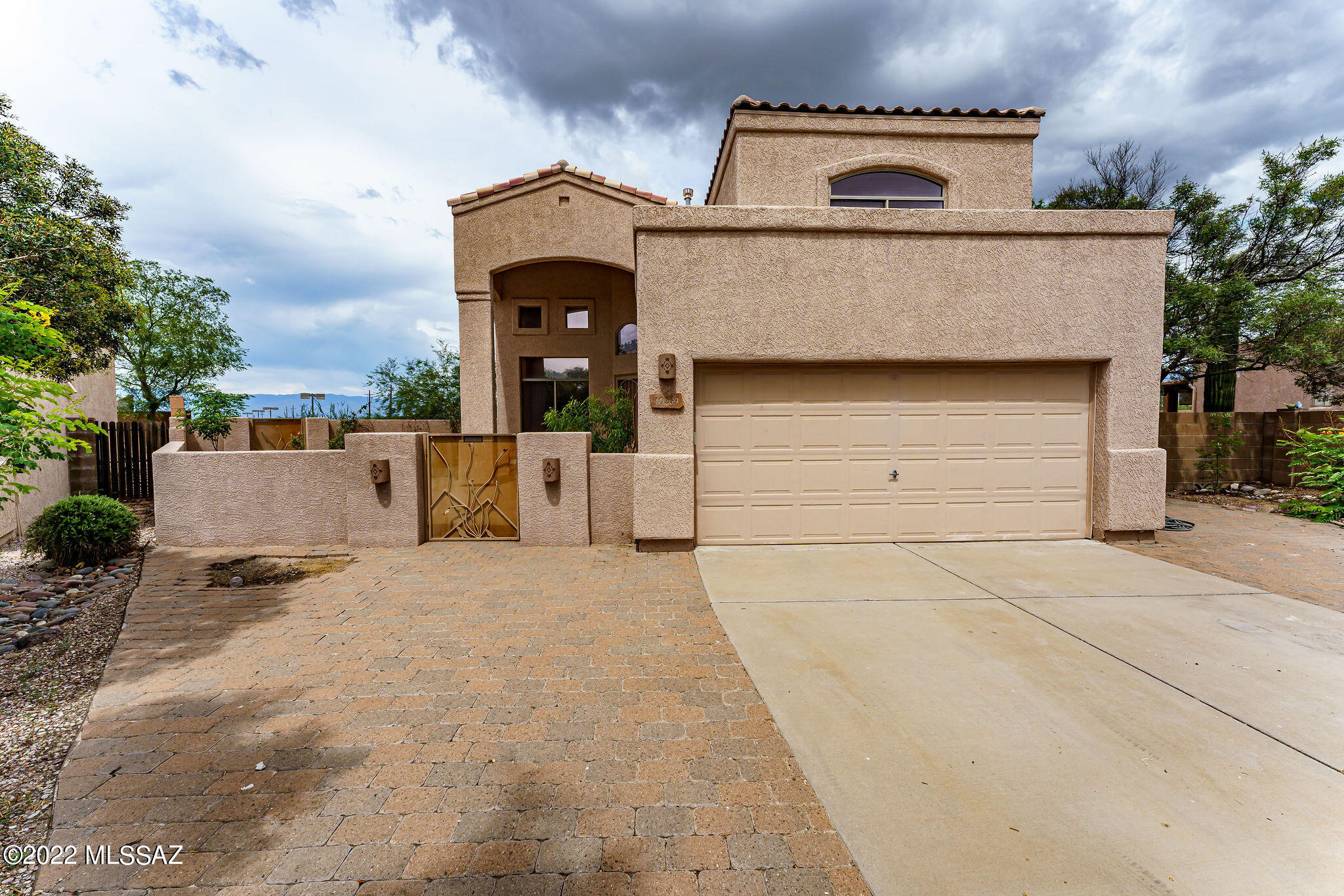 Open floorplan with a large family room, dining room and extra living room and a Grand staircase and high ceilings. These 5 bedrooms (one downstairs) and 3 bathrooms is a fantastic home for any family.  The master bedroom suite has new flooring, two closets, a garden tub, dual sinks w/ new faucets and a walk in shower and balcony. Kitchen has stainless steel appliances which include a new gas range, new stainless-steel sink, microwave, dishwasher, and a French door refrigerator.  Granite countertops and a center island with seating for 3. One of the largest lots in the subdivision at 10,332 sq. ft, surrounded by a block wall and lots of vegetation. Great mountain views. Beautiful fenced pool with spa and a Variable speed pump.  Large covered patio and a fire pit with large concrete deck. New interior Paint, New toilets, vanity lights, faucets and no carpet..... Courtyard entry, two car garage and a large concrete driveway.