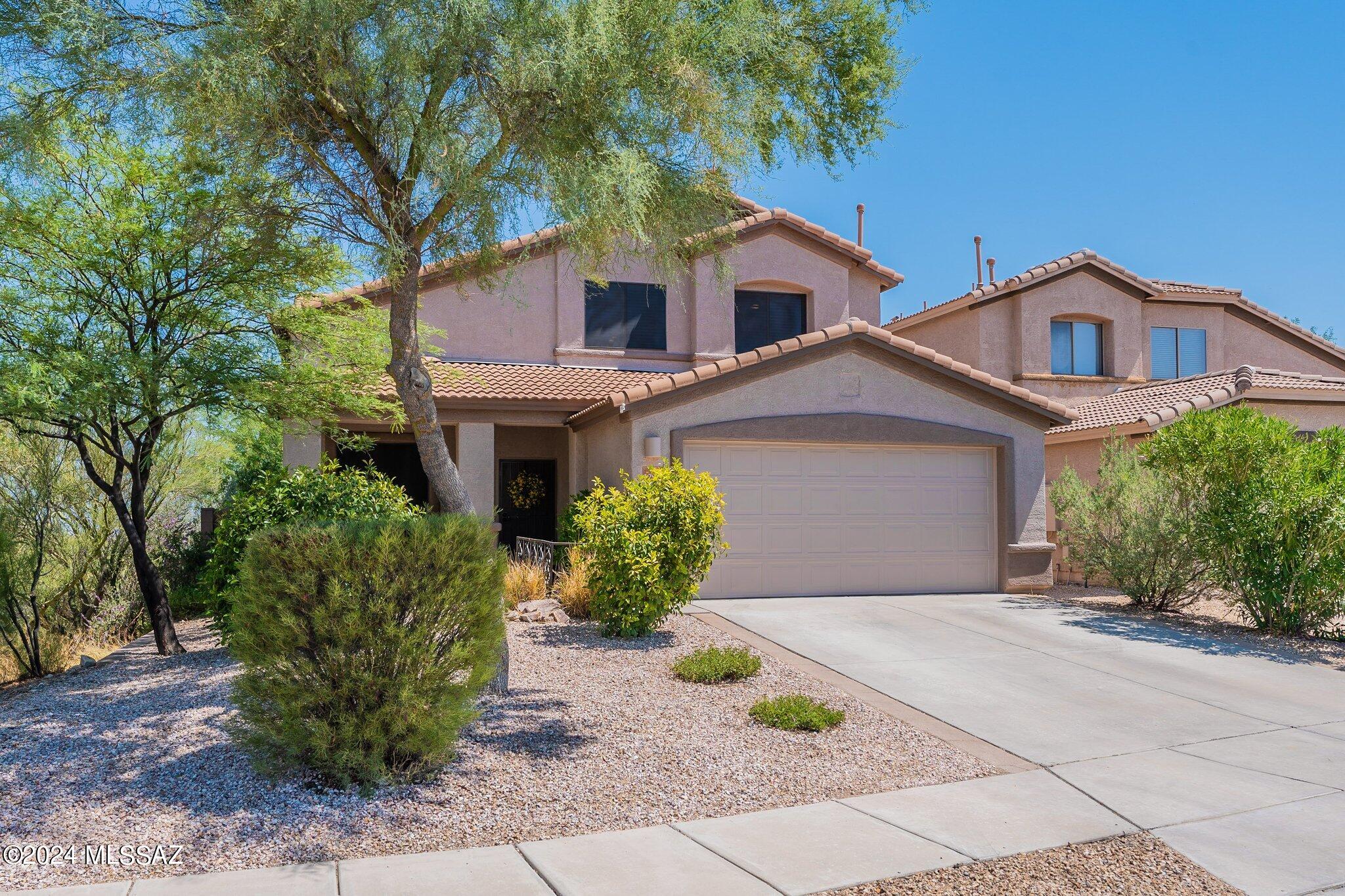 Location, location, location with impeccable views! This stunning 2-story home boasts breathtaking Rincon Mountain views and offers a perfect blend of comfort and elegance. With 3 spacious bedrooms, plus a versatile den, and 3 full bathrooms, there's plenty of room for everyone. The beautifully updated kitchen has entertainer's island with white rock backsplash, Corian countertops, black appliances, walk-in pantry and plenty of cabinet space. The kitchen opens up to great room concept living, perfect for entertaining! Downstairs has den, currently used as a bedroom, and half bath. Move your way up the beautiful stairs case, which overlooks the formal living room to the remaining bedrooms and bathrooms. Primary suite overlooks backyard and has STUNNING Rincon Mountain views. Enjoy a soak in the garden tub with equally gorgeous view. Once your squeaky clean, head over to the large walk-in closet with loads of storage! 2nd guest bedroom also has roomy walk-in closet as well! If the open-concept living isn't enough space for guests, take it outside to this gorgeous backyard that is a true oasis, perfect for entertaining as well. Extended paver patio is surrounded by low-care by lush vegetation that creates a serene, private and relaxing environment. The property is adjacent to wash area, and nothing behind the property except stunning mountain views, giving you only one adjacent neighbor! Don't miss your chance to own this exceptional property!