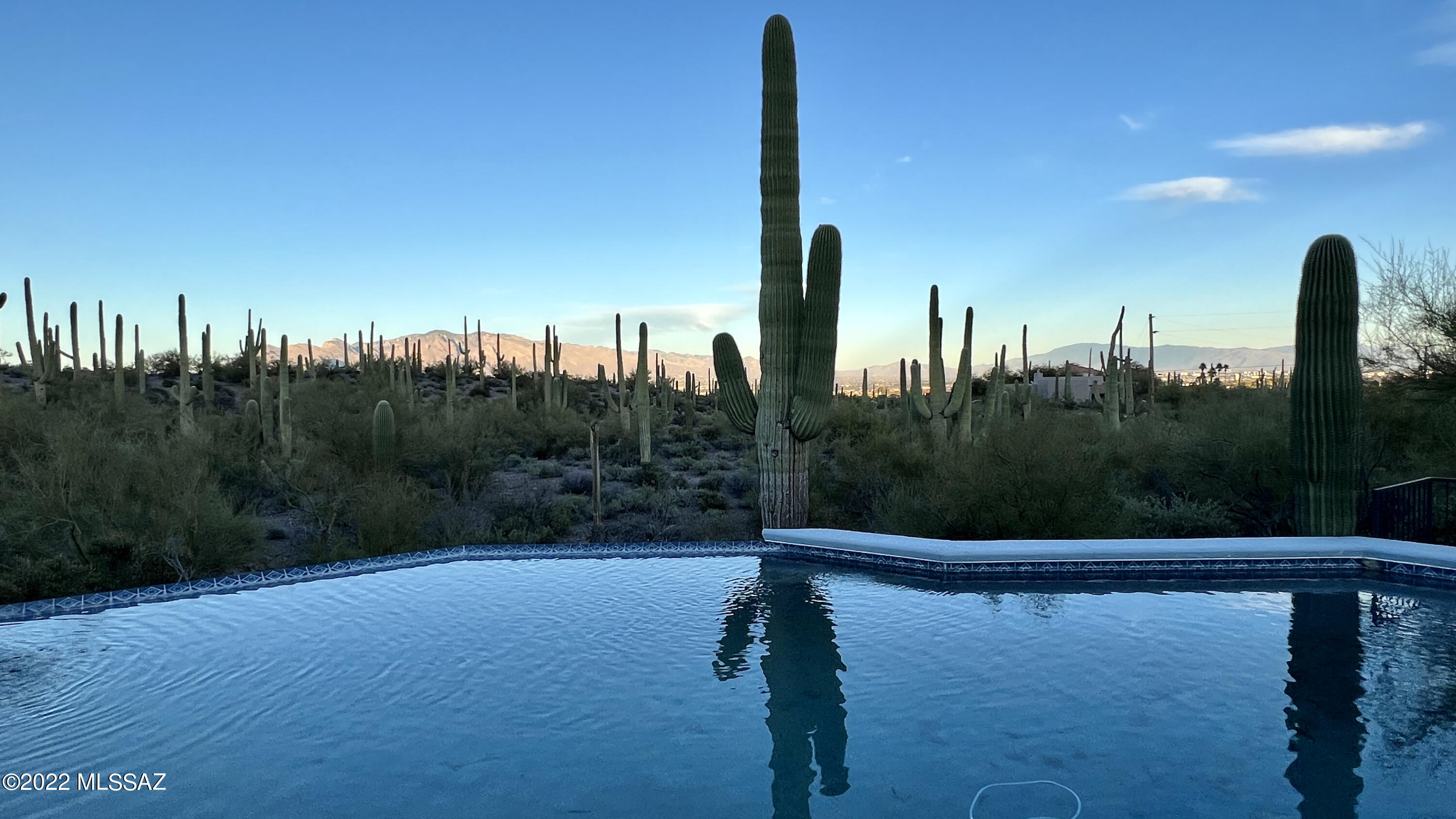 Welcome to this rare find in Sundance Estates. Private 2.2 acre property boost the most amazing city & mtn views.  Gated entry opens to welcome you to a meticulously cared for, custom-built home, 5 car garage (w/ wksp area) & separate art studio w/ outdoor sink. Enjoy stunning views from the oversized patio, negative edge pool, the spa w/ cascading rock waterfall or separate hot tub. This is outdoor living at its finest! Main house is an entertainer's dream! Features soaring ceilings, 3 bed, 3 bath, 2 living spaces, wet bar & so much more.  Gourmet kitchen features granite counters, custom tile work & Jenn-air oven & microwave.. Owner's bedroom is expansive w/ 3 large closets & private access to the hot tub. This home is truly a one-of-a-kind opportunity that seldom comes on the market!