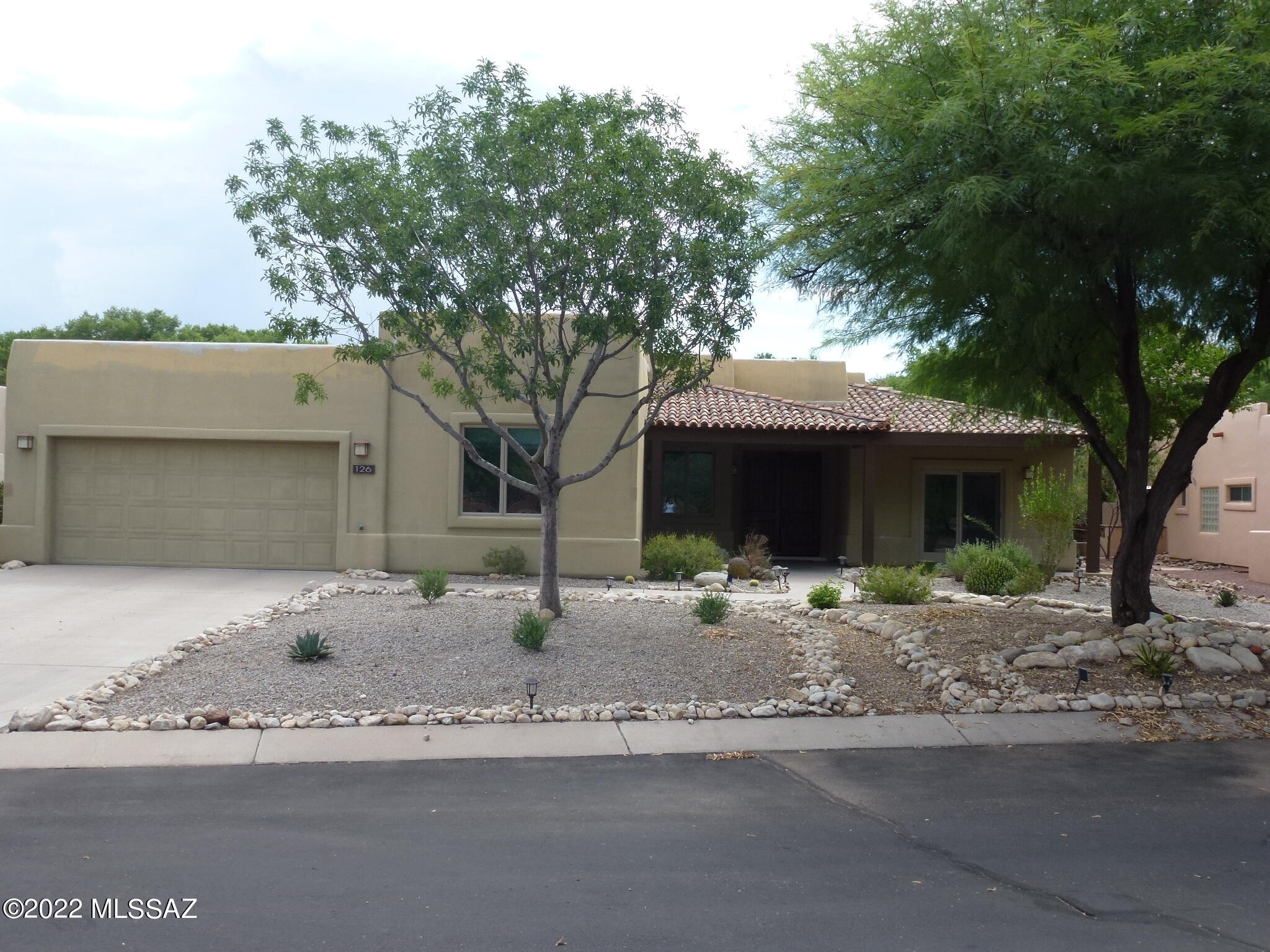 With large common areas in the front and backing to the De Anza trail and Santa Cruz river in the back, privacy surrounds this light & bright Dorn ''Durango'' expanded floor plan (3224 sq/ft) .   Plenty of space and flexibility, this 4 BR, 2.5 BA, features a large office area (BR or office can become den, library, media or rec rooms).  Oversized Anderson window and doors in the large great room magnify the rear yard, pool and surrounding landscapes. Large master bedroom and bath including closet built in's.   Large covered patio's in front and rear. A large rear wall with decorative iron top surrounds the solar heated swimming pool.   Rooftop solar panels and conversion system (owned) to offset electrical costs.