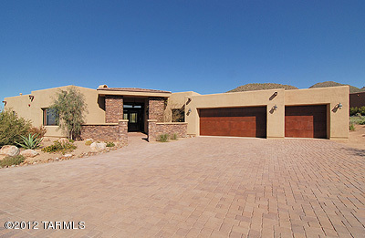 Custom Contemporary in the premier Luxury Guard Gated community of Canyon Pass at Dove Mountain overlooks the 2nd Fairway of the Gallery North Course. Situated near the entrance on just over an acre, an open flowing floor plan showcases an elegant Foyer, Great Room w/custom designed Fireplace and Dining area with Wet Bar, plus state-of-the-art Kitchen w/Breakfast Nook and sitting area. Wraparound Grand View windows, custom cabinetry & lighting, beautiful brickwork, and 8' solid core Alder doors throughout. Second Bedroom/Office adjacent to Master Suite features wood flooring. Outdoors you'll enjoy the expansive wraparound patio, relaxing Pool w/raised Spa overlooking the golf course, and stunning Tortolita mountain views. Athletic/Golf facilities available with paid membership.