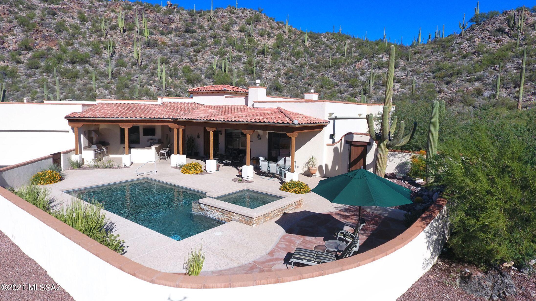 This 2984 SF custom home is as much a nature lover's sanctuary as it is an entertainer's paradise. Enjoy the best things in life from your 4.3 acre slice of heaven at the base of the Tortolita Mountains. The gourmet kitchen features ample storage space in the custom alder wood cabinets. High-end stainless steel GE monogram appliances and granite countertops bring this kitchen together to delight any foodie. The kitchen opens up to the large living room with picture windows and views in every direction. Step outside onto your back patio to practice putting on your very own green. Lace up your hiking boots and head out on your private hiking trail into the mountains to connect to the network of hiking, biking and ATV trails. Monsoon waterfalls are a short hike away. Breathtaking views!!