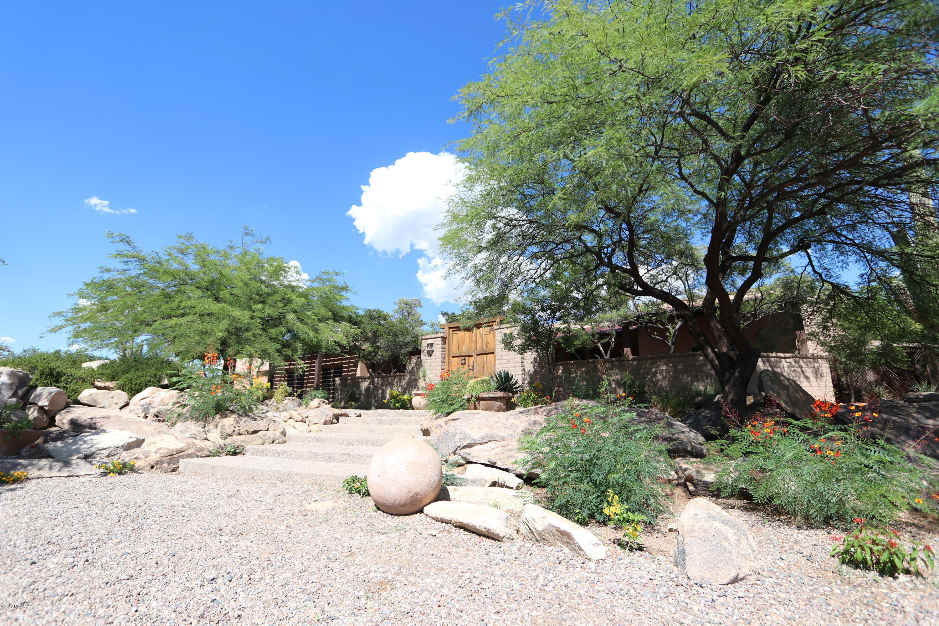 Seller will accept or counter offers between $1,150,000 and $1,250,000.  Private gated estate on gorgeous 10 acres with magnificent mountain, city, sunset, sunrise and starry sky views.   Stunning, true quality home with extraordinary resort like vibes. Huge library with beautiful wood shelving.  Chic gourmet kitchen.  Stained concrete floors throughout.  Feel like a celebrity with the luxurious, large walk in closets.  Room for horses, additional garages, gardens, RV, etc. Don't miss this incredible gem!