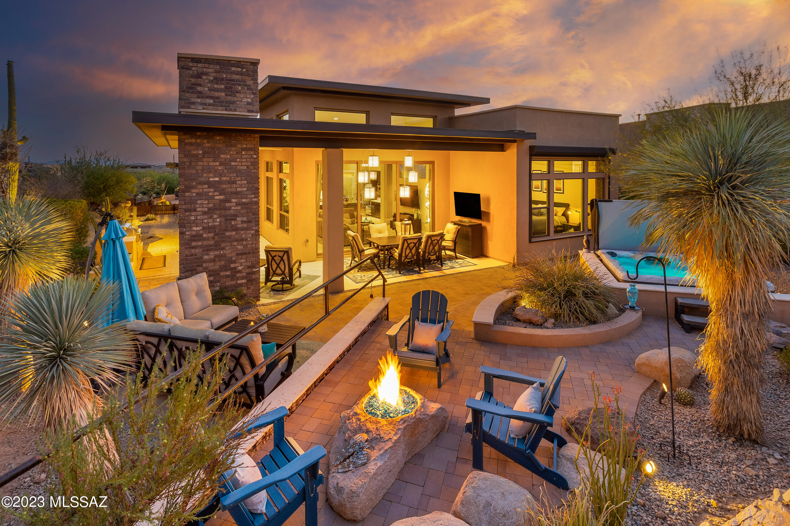 Elegant former model home boasts soaring 16' ceilings & stunning finishes. Kitchen with dramatic granite island juxtaposed against chic quartz surround counters & high-end appliances. Dining room & custom wine room overlook boulder-studded vistas. All bedrooms have ensuite baths & walk-in closets. Owners' suite features a custom closet, slipper tub & oversized glass shower.Triple slider opens to patio for seamless indoor/outdoor entertaining where you'll enjoy scenic views, fireplace, water feature, built-in grill, firepit, hot tub, & wraparound shade. Enjoy Stone Canyon lifestyle with world-class golf, clubhouse hosts restaurant,  health/fitness facility, lap pool,  tennis & pickleball. Whether year-round or seasonal resident, you will love the resort lifestyle & security of Stone Canyon