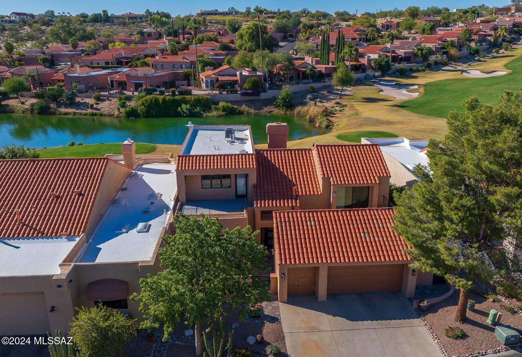 One of a kind, trophy estate, at the prestigious Tucson National Golf Community! This architectural engineered showpiece blends sophistication and comfort with over 3,000 square feet of versatile living space and backs up to the Sonoran Course at the 15th hole. 2017 Remodeled home features: exquisite 24X24 European tile by Unika, Bella engineered wood stairs, Knotty Alder Wood doors, Chef's Kitchen with luxury appliances, ground floor primary bedroom ensuite, additional family room/den, guest bedroom ensuite, large upstairs office with views of the Catalina Mtns. Expansive living and dining areas seamlessly connect to the beautiful outdoor spaces featuring a heated pool with Pentair Pump, BBQ, 2 firepits, a putting green with plenty of room to entertain! This remarkable find is rare!