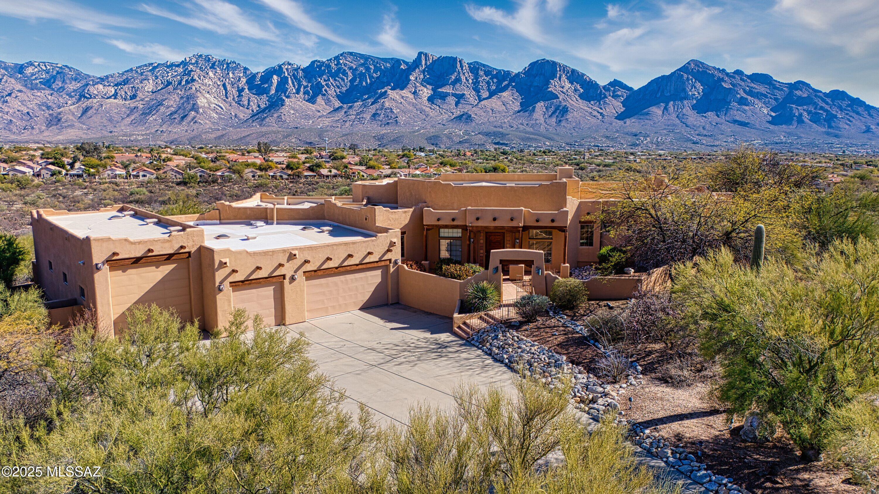 Nestled in the prestigious Coyote Ridge subdivision. This property offers breathtaking Catalina Mountain Views on 3.2 Acres. This custom Santa Fe-Style home features soaring 14-ft beam ceilings, 2 fireplaces, and a spacious game room with wet bar. Car enthusiasts will love the extra large RV Garage and oversized three-car garage. Due to Multiple offers Seller requests Highest and Best to be submitted within 48 hours.