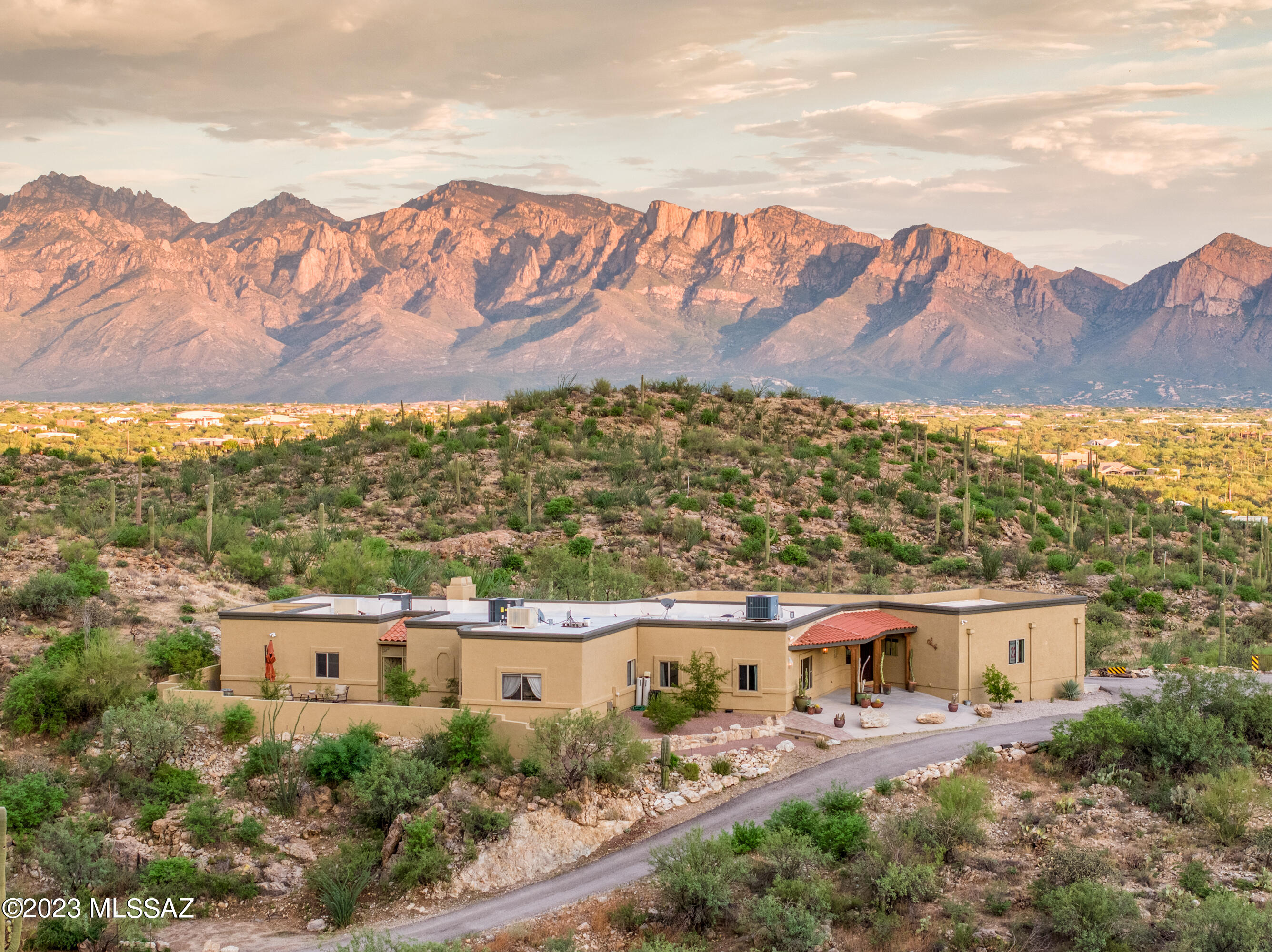 Welcome to the Tortolita Mountain hilltop retreat tucked back away from it all. Adore the evening view of the city lights framed by the Catalina mountains to the East and the Tucson Mountains to the West. 4 Acres of lush land to do as you wish.  Horse property, No HOA, space to build RV Garage, Stalls, Workshop, the possibilities are endless.  Water harvesting system with 3 tanks, the exterior is newly painted, new water heater and new HVAC systems. Inside you will find a large kitchen with granite counter tops, sit-down bar, built in wine glass rack and all the cabinet space you need. Dine in a lovely space with amazing views.  Living room with fireplace, master bedroom has large walk-in shower, soaking tub, his and hers walk-in closets and separate vanities. Everyone will love the oversized man cave/game room with bar & pool table. Outdoor patio spaces face southeast for the perfect orientation.  Large covered patios and outdoor fireplace and gazebo.  The perfect space to come home to, unwind and feel the peace and quiet of being nestled into the beautiful Tortolita Mountains.
