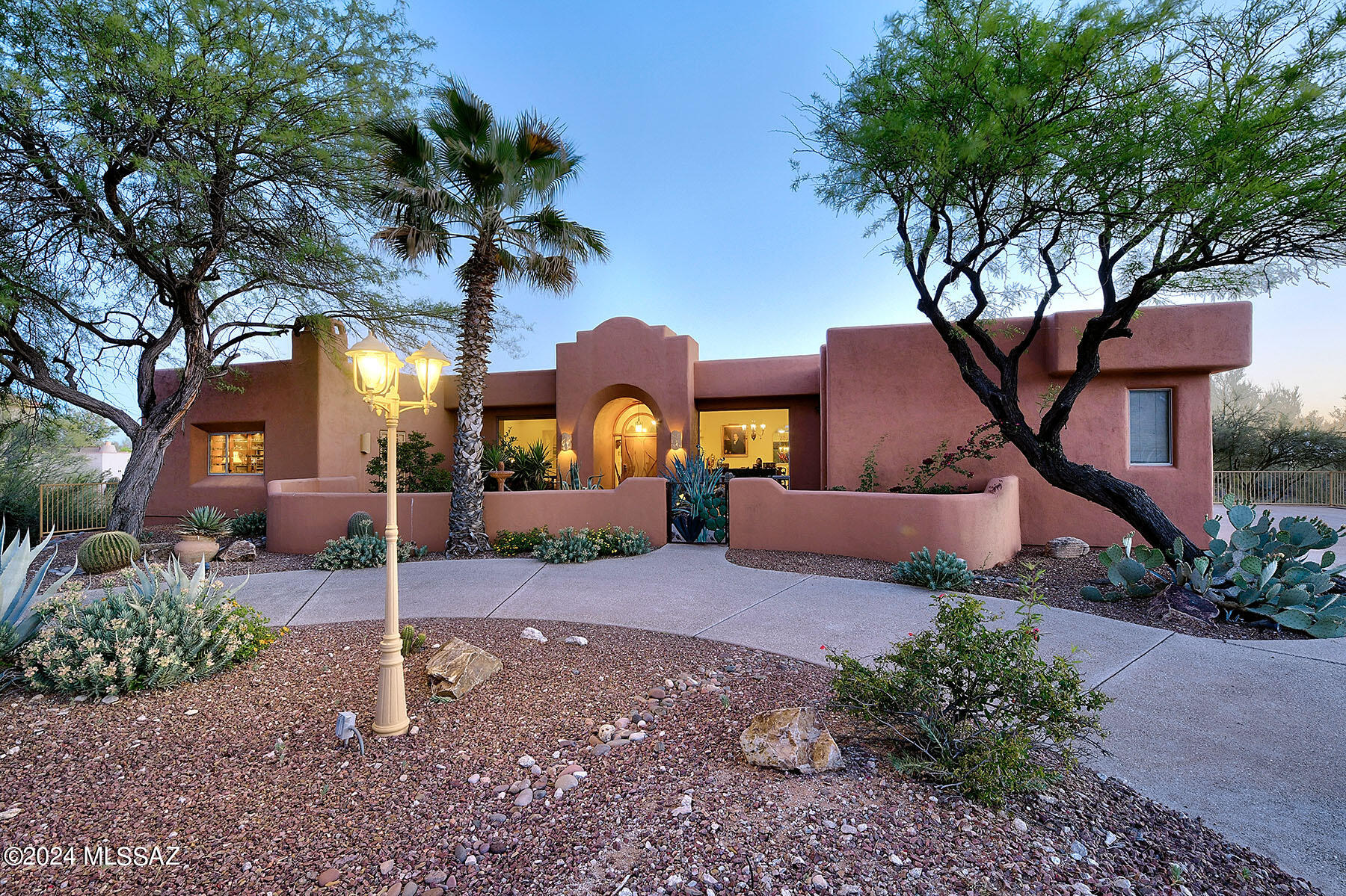 Welcome to Bellas Catalinas Estates - the prestigious gated foothills enclave of homes nestled on approximately 100 acres with gently rolling hills, arroyos, natural wildlife and lush Sonoran Desert vegetation. This custom single story home features four bedrooms & three bathrooms and offers Santa Catalina Mountain views as well as twinkling Tucson city light views - a quintessential Tucson estate home. As you enter through the front door, the welcoming foyer leads you to the living & dining areas that take full advantage of the mountain views. The living room is a perfect spot to curl up on the sofa with a good book while the dining room offers striking mountain views when you are enjoying your morning cappuccino. The open concept kitchen has a gas cooktop, double ovens, breakfast bar, double sink, huge pantry and a breakfast nook that overlooks the lush tranquil garden. The great room - with a gas fireplace, custom niches and sliding doors with access to the garden & pool - opens to the kitchen providing an open floor plan concept which is the perfect gathering space for family & friends. The primary suite offers dual vanities, walk-in shower, jetted tub, two closets (with one being a large walk-in) & a door which leads to the private backyard patio.  Split bedroom floorplan. Bedroom 2 - which could easily be a home office, offers beautiful built-in bookcases, lighted ceiling fan, large walk-in closet, exterior access and great mountain views. 

Enjoy fabulous entertaining and dining outdoors on the patio watching the incredibly vibrant sunrises & sunsets while immersing yourself in the beauty of the Sonoran Desert. Luxury living at its best with a resort style backyard showcasing a refreshing heated pool with water feature, gas fireplace, extended covered patio, flagstone and multiple outdoor seating areas all bordering a vast common area. This dramatic setting offers an inviting & relaxing atmosphere to entertain year round while enjoying the indoor/outdoor lifestyle so prevalent in Tucson.

Sited on .99 acre, this serene sanctuary maintains a sense of seclusion in the lush Sonoran desert offering native vegetation including Saguaro cacti, shady mesquite trees, orange flowering ocotillo, flowering lantana, agave, as well as Texas Ranger with its vibrant purple flowers. Many, many upgrades including Energy Star designated home, oversized three car garage, separate laundry room with sink & plenty of cabinets, skylights, lighted ceiling fans, wrought iron security doors, front & rear water fountains, drip irrigation system and storage galore. Two zoned HVAC units. Close to the bike loop, great hiking, world class golf, resorts and fine dining.  A true oasis in the Sonoran Desert.