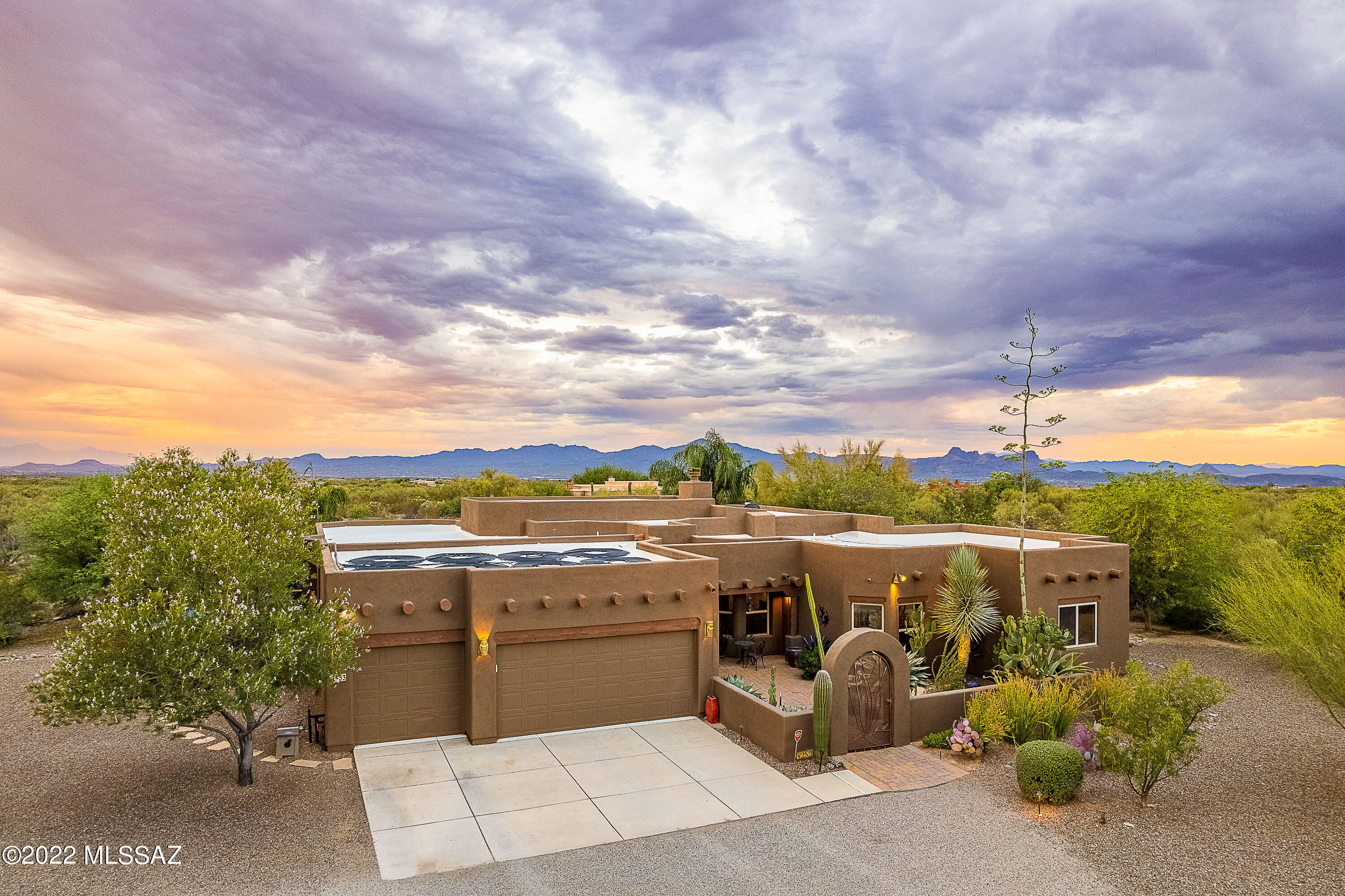 PRIVATE desert oasis on 3.56 acres. 360° VIEWS!! Tortolitas,Catalinas & Downtown. Professionally designed resort backyard w/solar/gas heated pebble tech pool, custom lighting, spa, rock fountain, ramada, gas fire pit, built in grill ,TV/DVD and commercial misters. Lush vegetation w/ multiple fruit trees. Gated front courtyard, 2,996 SF, 5bd/3bth, vaulted ceilings, entertainment area w/ built in wine bar & wine fridge. LR with custom built in/lighted cabinetry & dual sided fireplace to DR. Open kitchen with breakfast bar overlooking the family room, 3 car garage, space for add'l storage; RV hookup. Property meticulously maintained & includes Security System, Water Softener, Sprinkler/Drip system, Fire Protection Sprinkler System.