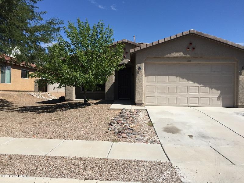 This 3 bedroom 2 bath home is ready for an immediate move in. Your home is facing west with full view of mountains and sunset, no home across the street to block your enjoyment of Tucson's beautiful sunsets! Home is located on a lot with extra space between your north side neighbor via a 10 ft. easement. Open floor plan with large great room, large tiled entry and spacious family room off your open kitchen complete with a breakfast nook and center island, executive height maple cainets with pull out shelving, black appliances. 9ft ceilings, professionally painted textured walls with rounded corners. Spacious master bedroom with ceiling fan, custom mirrored closet doors, master garden tub and shower and a sliding glass door leading to your back covered patio. Trash included.
