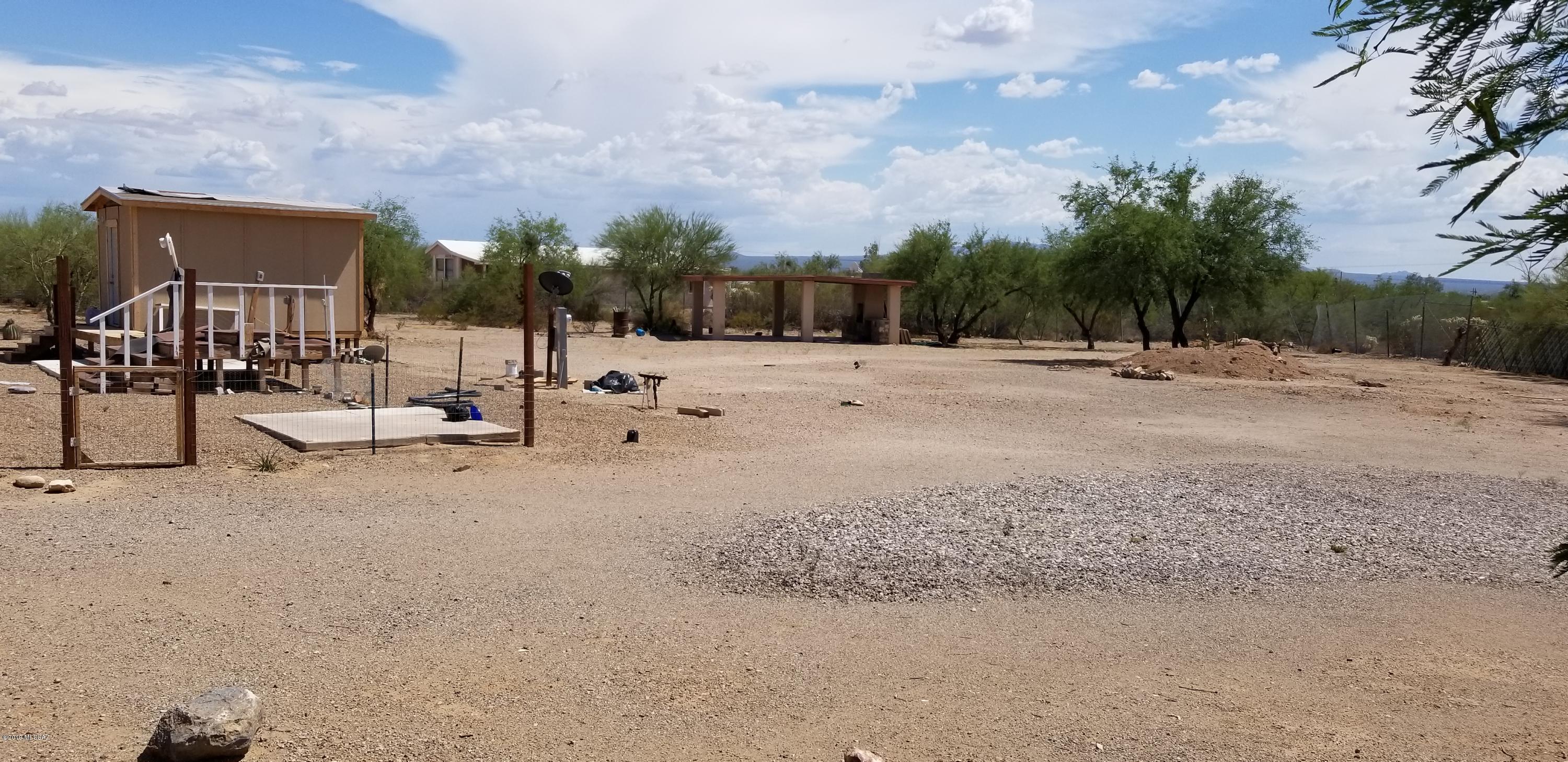 Acre lot completely fenced with 2 access gates.
All utilities onsite ready for your home.  Breath taking mountain views! Located right off the pavement close to Tucson yet near by to all your shopping needs. Acre is landscaped ready for your home or RV,  equipped with a 2 car carport and built-in barbeque and storage shed.  Enjoy the unobstructed views of the mountains from your existing viewing deck.