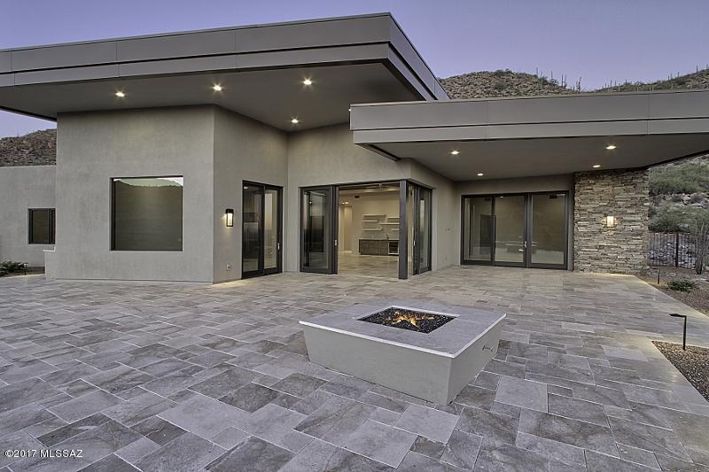 Brand New 4BR/4.5BA Contemporary on 2+ acre lot in picturesque, guard gated Canyon Pass at Dove Mountain. Nestled within the Tortolitas, this striking custom home boasts sleek lines and panoramic Canyon, Golf Course, Sunset and City Light views! Gated Front Courtyard opens to an impressive Great Room boasting floor-to-ceiling stacked stone Fireplace, 10-foot-high retractable sliders, 500-bottle Wine Room, Wet Bar, formal Dining, plus state-of-the-art Kitchen featuring Sub-Zero and Wolf appliances. Spacious Master Suite hosts a cozy fireplace, elegantly appointed bath, and huge walk-in closet w/built-ins. Remaining bedrooms (or office) feature ensuites. Magnificent outdoor living encompasses an infinity Pool/Spa, firepit and built-in grill w/bar. Ritz-Carlton and Gallery Golf Club nearby!