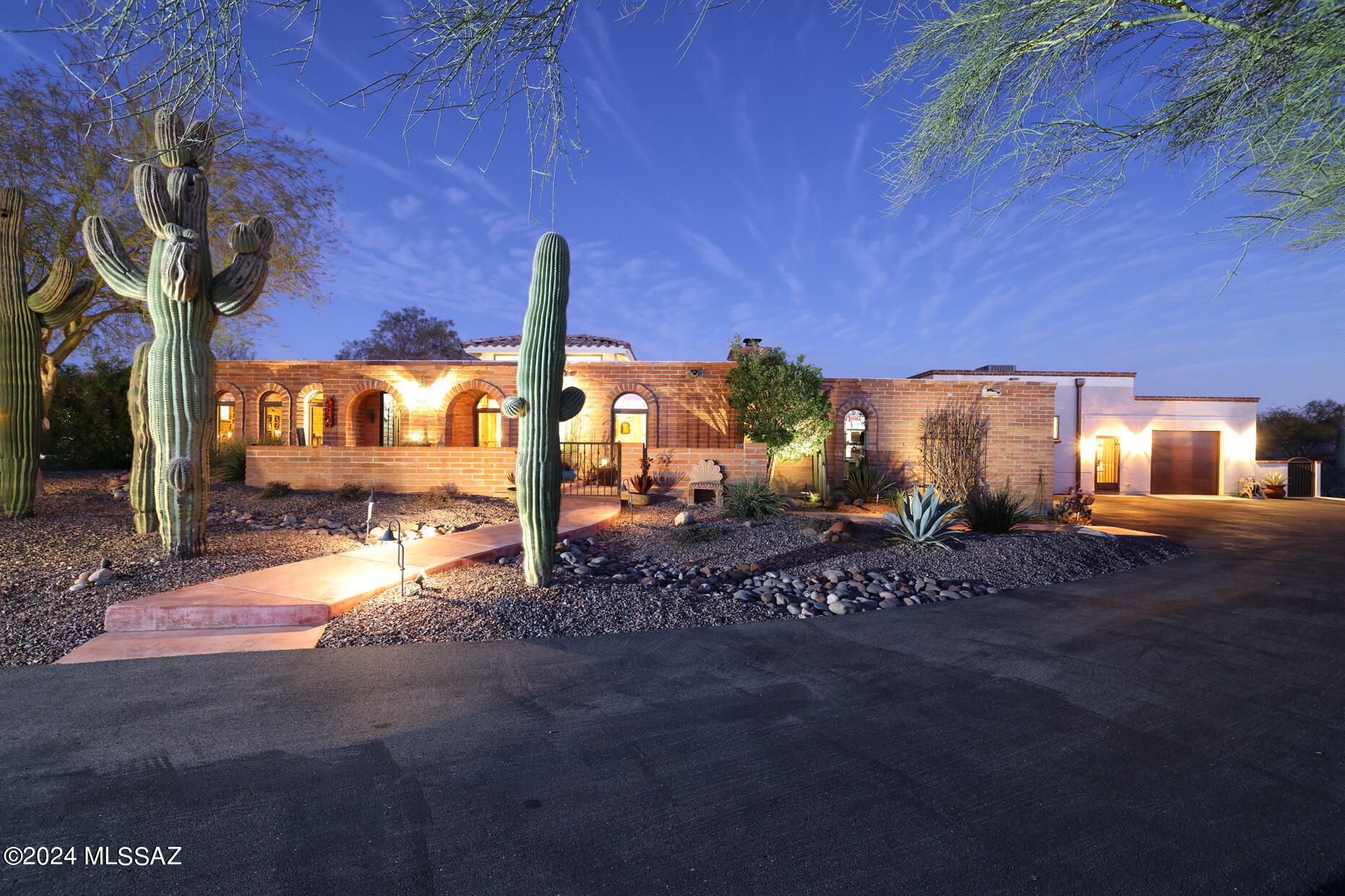 Stunning Burnt Adobe Territorial Offers an Exceptional Experience-Spacious Layout, Unobstructed Panoramic Mountain Views & Meticulously Updated Features.   Situated on almost an acre(.92), is a beautifully remodeled backyard-renovated pool, spa & extended back patio. Comfort and privacy affords this ample 3376 sq ft with 4 bedrooms (2 Primary En Suites) & 4 baths.  In 2019 Impressive addition-811 sq ft livable space includes 2nd Primary En Suite, laundry room, office with built-ins, plus third heated/cooled garage/workshop.  The open design seamlessly connects dining room, family and living room creating an inviting atmosphere to gather.
Kitchen boasts solid hickory cabinets, soapstone counter, island, S/S Kitchen Aid appliances and fabulous butler's pantry with wine cooler. All baths updated. Attentions to detail is evident throughout-tankless water heaters, newer Pella windows, replaced interior/exterior doors enhancing energy efficiency & appeal.  With the combinations of modern updates and preserved character, this Rare Gem offers a unique opportunity to experience luxurious living in Oro Valley.  (Two cats in house - they hide - please close doors to the outside).  Thanks