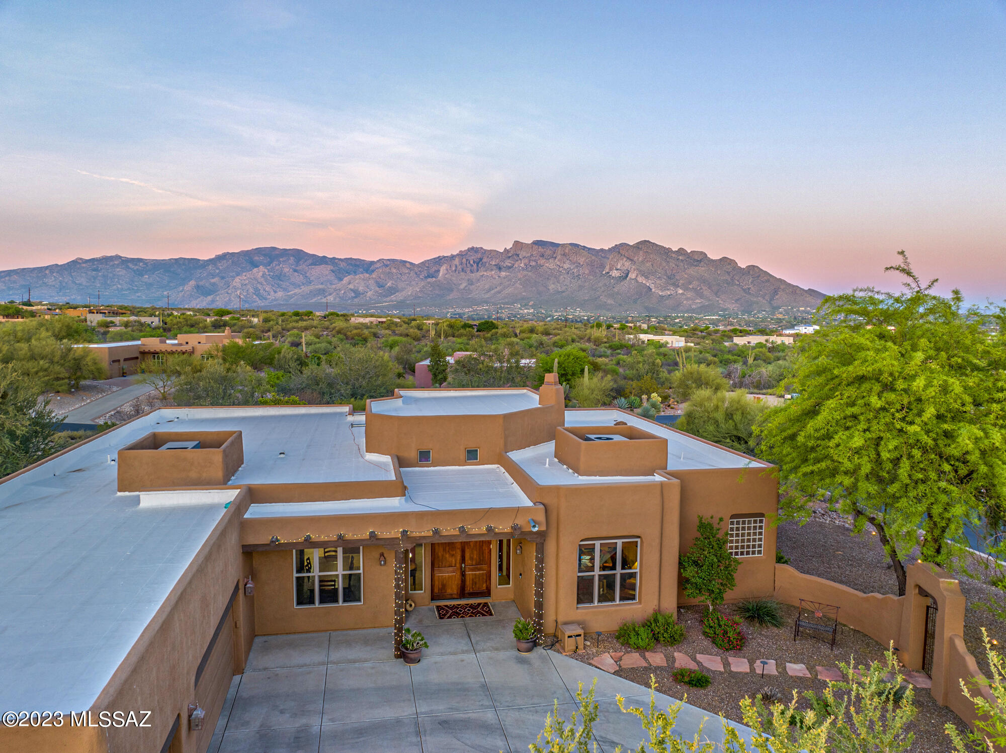 Nestled within the highly desirable Chaparral Heights community in Oro Valley, this stunning Southwest contemporary property exudes architectural elegance, superior craftsmanship, and intricate custom detailing throughout. With a single-level design and expansive 3476 sqft of living space, this home features 4 bedrooms, 3.5 baths and is perfectly situated to capture breathtaking panoramic mountain views. Upon entering, you'll be captivated by the warm and inviting interior, with celestory ceilings, window walls in the living room, and arched hallways leading to each beautifully appointed bedroom. An inviting gated courtyard welcomes you, providing a tranquil setting to unwind and enjoy multiple patios, including a formal dining area and a cozy breakfast nook. The great room boasts a wall of windows, hand-peeled vega beams and a kiva fireplace, creating the ideal space to relax and unwind after a long day. The primary bedroom is a luxurious retreat, complete with executive height vanities, custom knotty alder cabinets, a soaking tub and designer bronze plumbing fixtures.

The formal dining room is equally impressive, with a hand-forged wrought iron cast candelabra light fixture, glass candle lights and French doors leading to a veranda with a gas firepit on intricate porch pavers. The garage is a dream space, with an oversized 3-car garage and deep, rich brown garage doors.

The backyard oasis faces east towards Pusch Ridge and boasts stunning sunrise views and colorful sunsets, with natural desert sounds and chirps providing a peaceful and serene atmosphere on its 1-acre lot. The firepit, putting green and pool with raised spa and spillway make it perfect for relaxation or entertainment.

This property is truly a masterpiece, showcasing exceptional design and meticulous attention to detail, making it a must-see for anyone seeking luxurious living in Oro Valley.