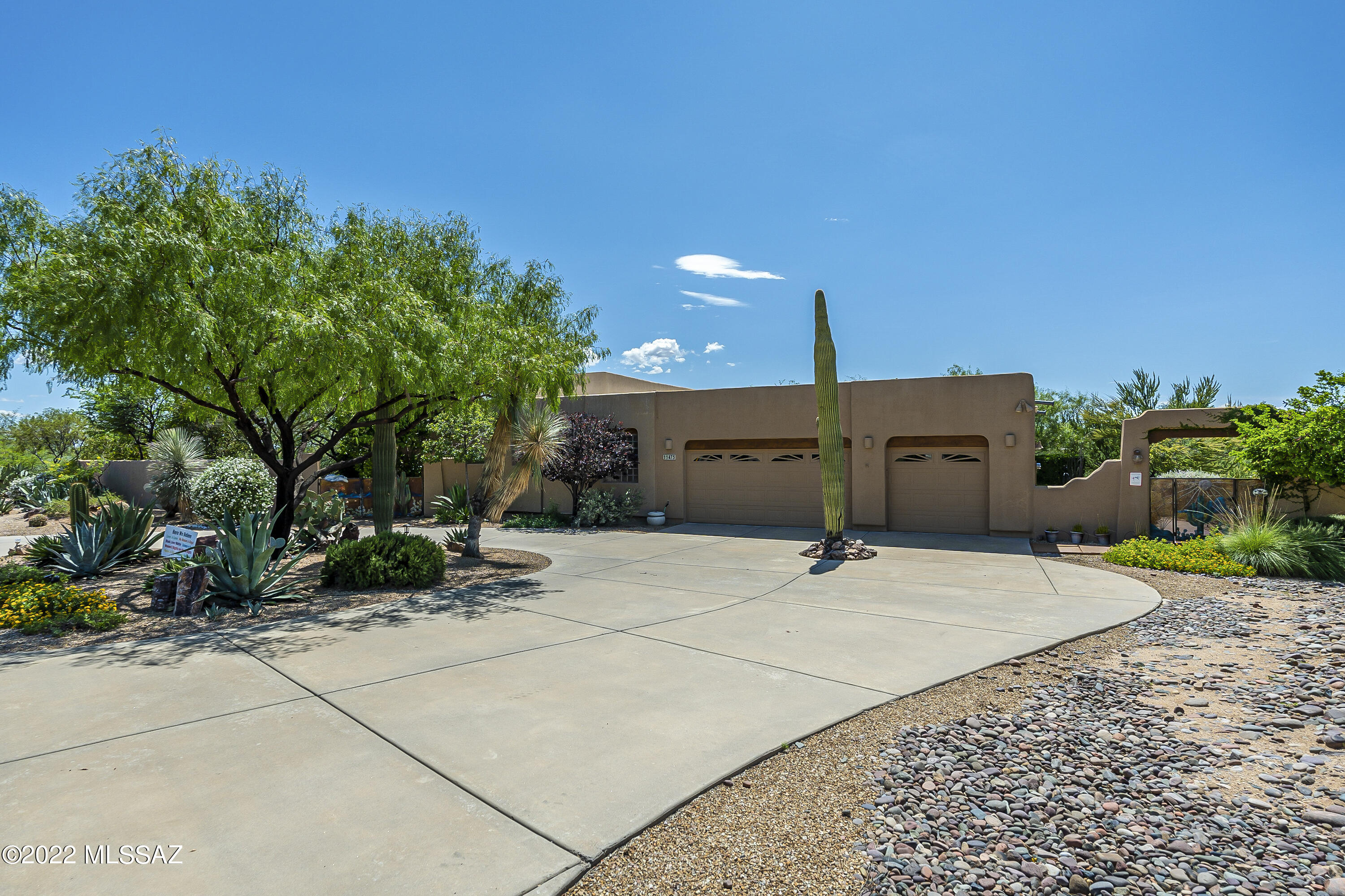 Come take a look at this beautiful home located in the heart of Oro Valley. You will enjoy the tranquility and quiet desert surroundings of this delightful home sitting on 3.4 acres! The yard to this home has been recognized by the Tucson Audubon Society for its value to birds, butterflies, and wildlife. Once you step into the courtyard you immediately get the Zen feeling. Walking into the home you will notice the natural light beaming into it, the beautiful, stained concrete and the marvelous wooden columns that lead into the living room with beautiful bay windows and 16-foot ceilings tastefully composed of vigas and wooden planks. Kitchen has been recently remodeled with Hickory wood cabinets and a beautiful granite countertop. The rounded oversized kitchen island is a great focal point. All interior/exterior doors are solid mahogany wood. Backyard is truly an oasis with a wonderful Koi Pond. Many updates and features such as custom wrought iron gates, lighted exterior wall perimeter, exterior wall view fence, garage has been chip floor coated, stainless master bathroom sinks, beehive fireplace in living room and much more. Home is positioned perfectly to enjoy backyard at any time without having to worry of direct beaming sunlight. This home is a prime example for pride of ownership.