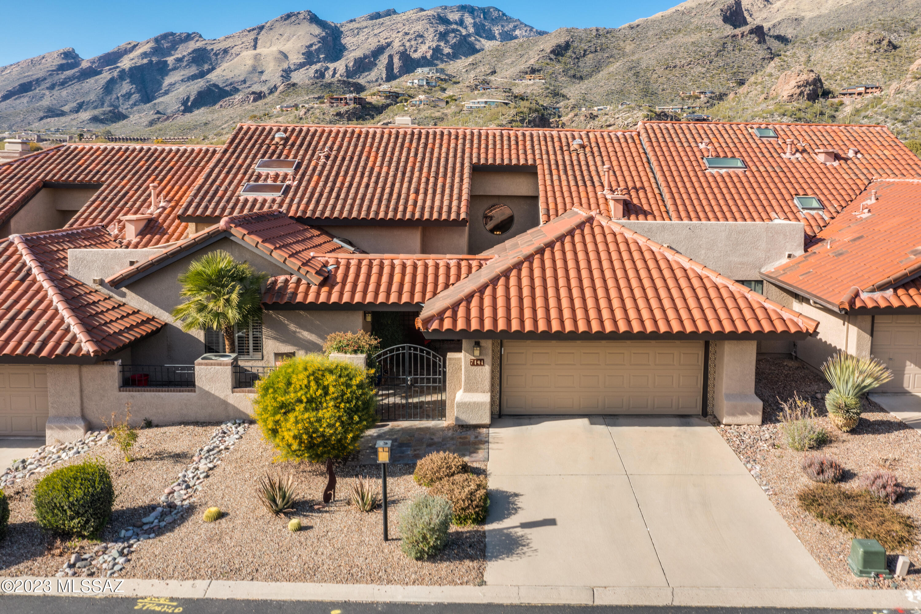 Stunning townhome in prestigious Ventana Canyon. Appointments of the highest quality & no detail overlooked. Gourmet kitchen features Sub Zero refrigerator, Dacor double oven, warming drawer, Gaggenau modular cooktop w/gas & electric burners, steamer & deep fryer. Granite countertops & butcher block island complement the custom cabinetry. living rm features a beautiful stone/copper gas log fireplace as a focal point, soaring vaulted ceilings, mountain & golf course views. Two large ensuite bedrooms w/2 walk-in closets in the primary  bedroom. Newly remodeled patio w/pavers, built-in BBQ, beautiful new gas/colored glass fireplace for ambiance w/panoramic mountain & golf course views. Meticulous updates to the home include new AC/heat 2021, water htr 2021,LED lighting 2020, solar tubes added