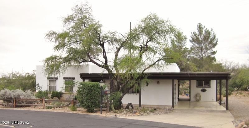 A rare find, in Continental Vistas, for the buyer who wants the perfect space and location, with a private desert garden.  This home is surrounded by lush vegetation and privacy, making it your own oasis in the desert. There are fabulous Santa Rita Mtn. views from the front, and in the back yard, there is total privacy for your relaxing pleasure and entertaining space, surrounded by the verdant green growth!  Inside, there are endless possibilities for the 2 BR, 2 Ba home.  Kitchen has newer appliances.  Baths and Kitchen are original. Murphy bed in Guest BR stays.  There is a separate laundry in the adjoining storage room with W/D and lots of storage space.  Single, covered, attached carport with extra space (graveled) for second or more vehicles, or build a garage!  With some TLC, this home will become your own special, treasured space!