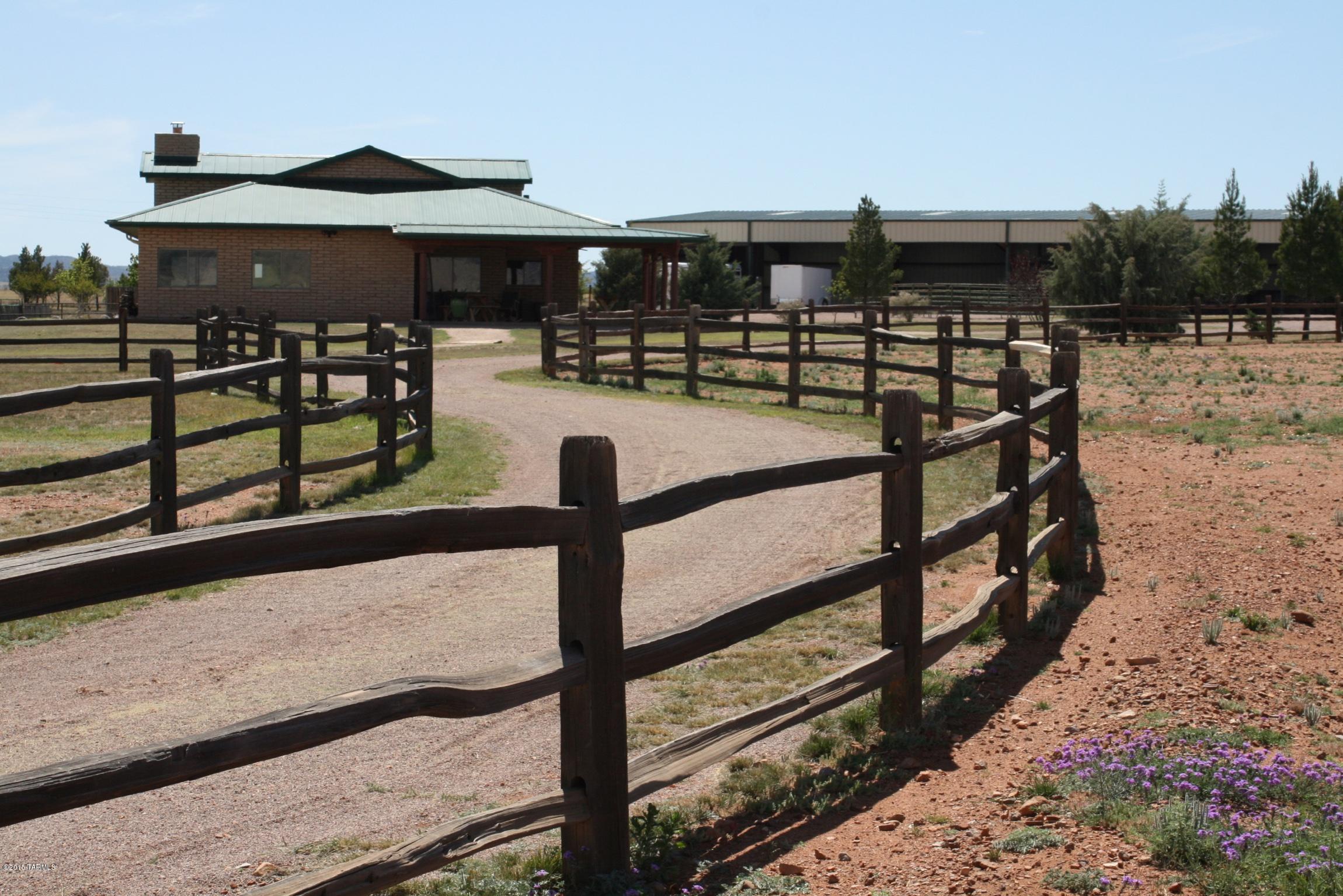 This is a masterpiece built with love by the owner who has created a special horse property that has been used as a non-profit to benefit those in need of nature's therapy. The property has 2,755 sq.ft. main house, a 438 Sq.ft. cottage, an enclosed 11,000 sq.ft. covered horse arena, 1000 sq. ft. cooled & heated green house with fish pond and fountain, 6000 sq.ft. irrigated garden, 1200 sq.ft. main barn with feed room and workshop,739 sq.ft. 2nd Barn with Tack room, feed storage, covered hay storage, three fenced turnout arenas with pastures, round pen, pens for rabbits, goats, chickens, tortuses, Water Well with back up generator. BUILDINGS ARE WHEELCHAIR ACCESSIBLE  Panoramic views in all directions. This is a MUST SEE to believe. For more pic's and information go to treehousefarm.org