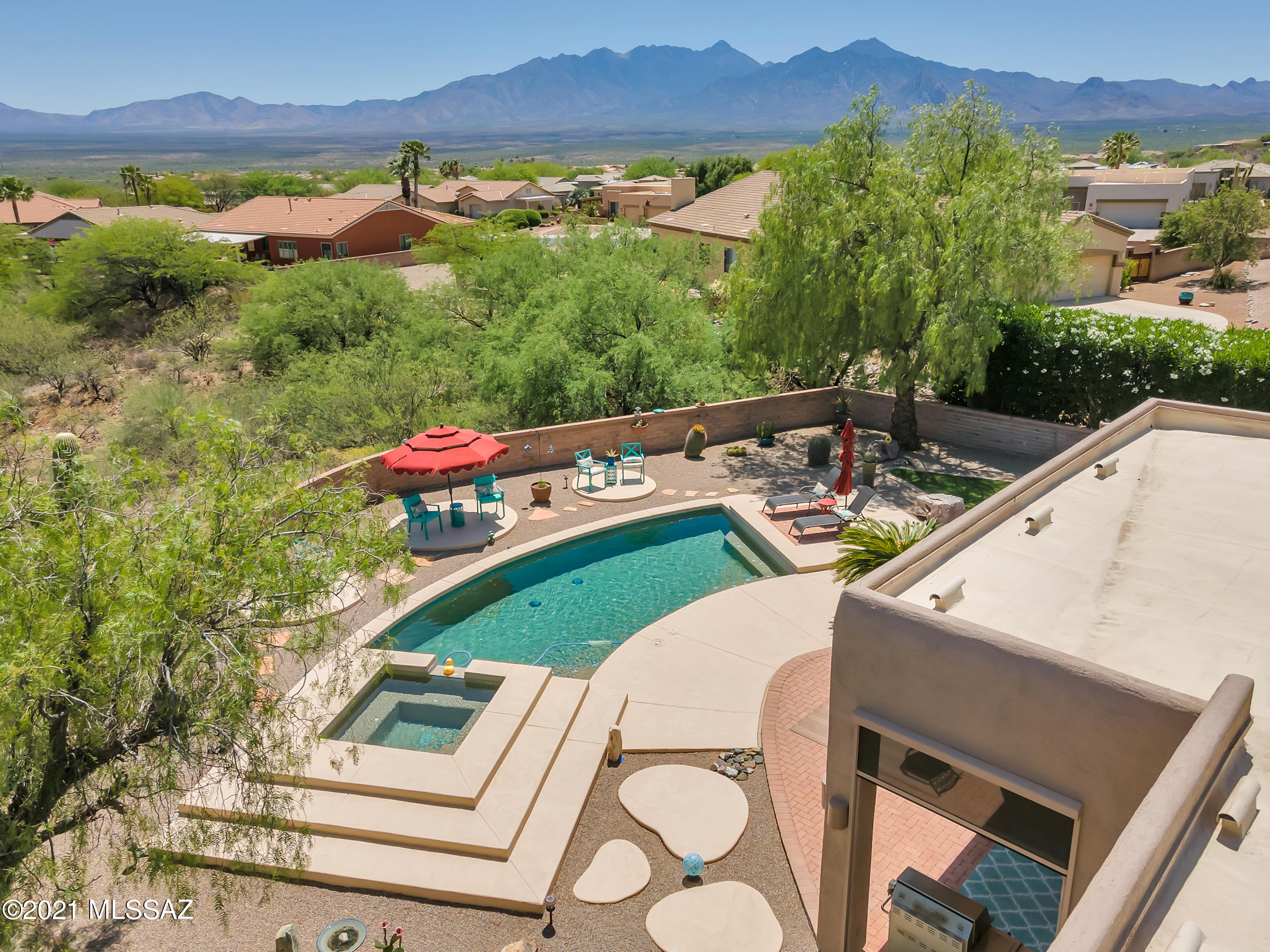 Exceptional, exquisite, private executive home. Elevated lot on 1.66 spacious acres; nestled in the heart of a Green Valley gated community.  ''Your serene and peaceful desert oasis awaits you here''.  Enjoy complete privacy and comfort all 12 months of the year, inside and out, this home pleases even the most discriminating buyer.  Tastefully updated, light and bright throughout; a place where natural desert beauty, flora and fauna abound.  A daily pleasure watching all four seasons of the year change right before your eyes. Surrounded by sweeping panoramic mountain vistas and the Santa Cruz valley below.  Your viewing pleasure begins at pool side, listening to the sound system playing your favorite tunes.  Enjoy entertaining, music, BBQs, family gatherings and fun at your sparkling Pool & Spa.
A very special home, make your holiday memories here, gathered around the fireplace or watching a big screen together.  
Gated, private, front courtyard, the sun and shade patterns play upon the landscape throughout the day.  Inviting courtyard gathering areas for conversations, friends, coffee, cocktails; so cool and comfortable listening to soothing sounds of the cascading waterfall.   Your backyard resort with workout pebble tec heated Pool & spillover Spa has special massaging jets, low water pump w/energy efficient computer device.  Wired surround sound in family room & patio, new remote control sun shades out back.  A must visit home to appreciate the wide expanse of 1.66 acres and panoramic views.