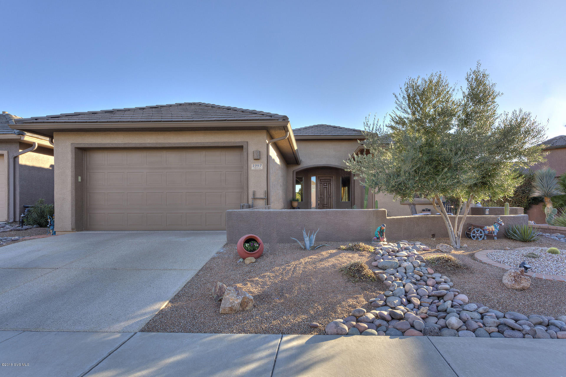 From the welcoming entry courtyard, you'll enter this wonderful 2Bd/2Ba + den home with open floor plan and wonderful back patio views of the Santa Rita Mountains. Notice the honed-stone countertops in the kitchen and the granite on the bathroom vanities. The spacious back yard is perfect for entertaining or just enjoying the peaceful views. There is even a workshop area in the garage. And if you love golf, 2 courses within 5 minutes. Stop by to see for yourself!