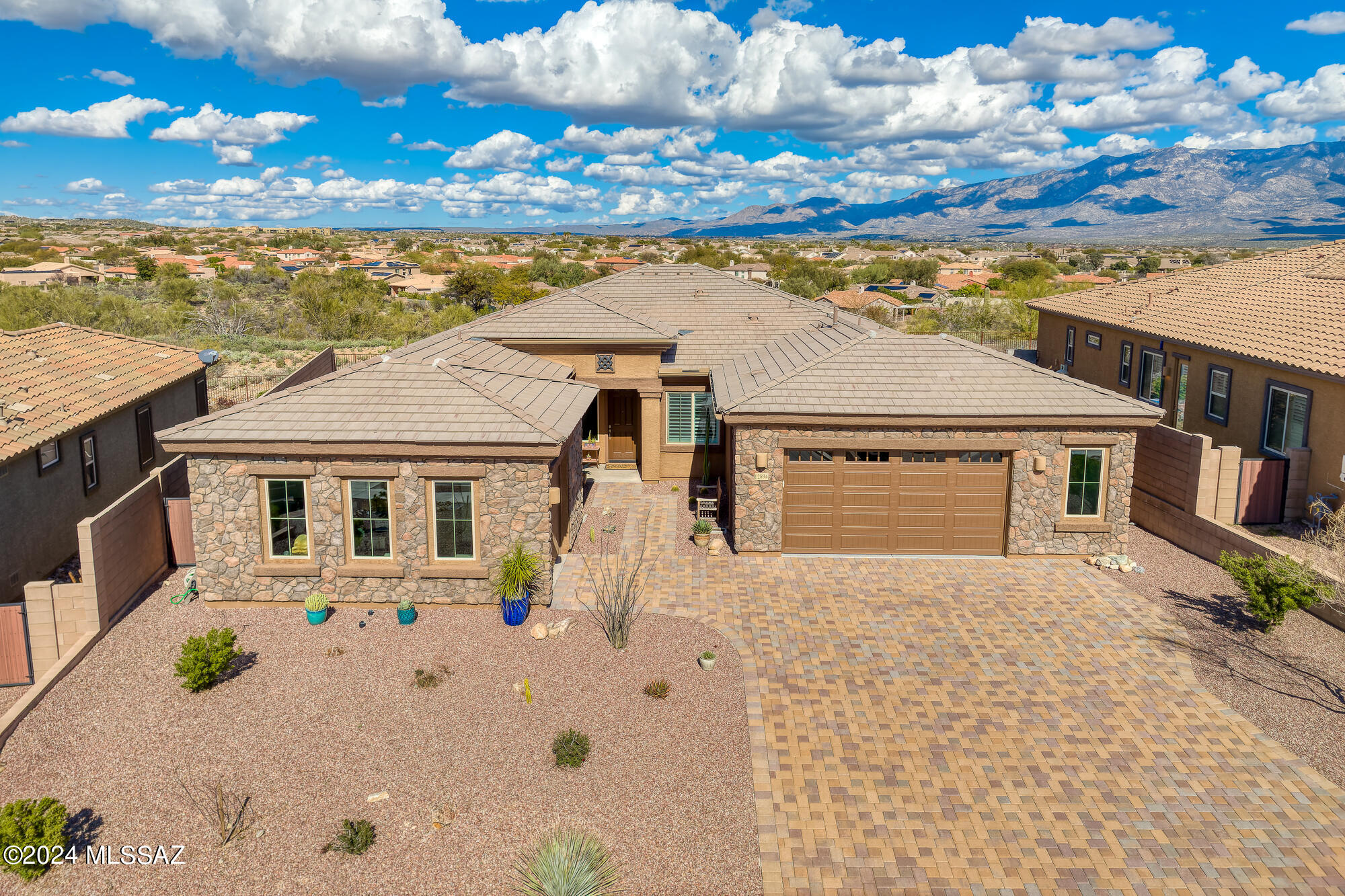 Stunning views from this like-new Lennar built home in the heart of Oro Valley. Ceramic tile throughout except den. Ideal split floor plan with three bedrooms, den, formal dining room, 3 car split garage.  Oversized laundry room connects the primary bath and the hallway. During the last seven months, window and slider treatments are all brand new. new lighting, interior paint, and kitchen counters have been replaced with slab Cambria quartz and new backsplash.  Private back yard with nothing behind the home except glorious mountains.  Convenient to all the Oro Valley amenities.
