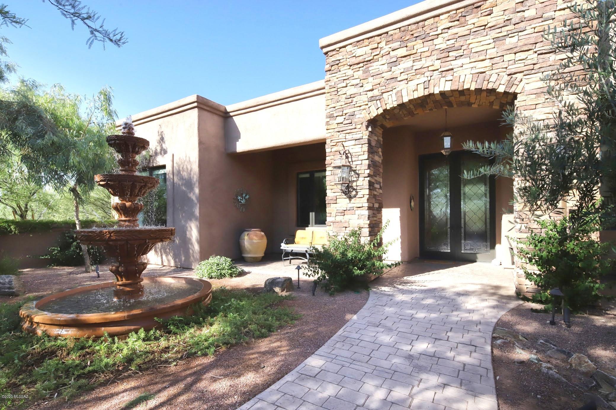 Mountain views, luxurious finishes, sophistication and attention to detail abound in this gorgeous home with backyard oasis, open floorplan, lavish master suite & everything you would demand for upscale living. Front courtyard w/fountain & superb leaded glass entry doors set the stage as you enter the formal living & dining spaces. Dream kitchen w/top of the line appliances, cabinetry & live-edge granite is open to the nook & grtrm w/French doors & striking FP. Lush backyard offers a sparkling pool & spa w/2 waterfalls, lg covered patio & mtn views for amazing outdoor living. Vast Mstr Ste w/views, rain shower & elegant soaking tub. Two addl guest bedrooms w/full ensuite baths & 4th bdrm makes an amazing den. Travertine & stacked stone details throughout, fully enclosed RV garage & no HOA.