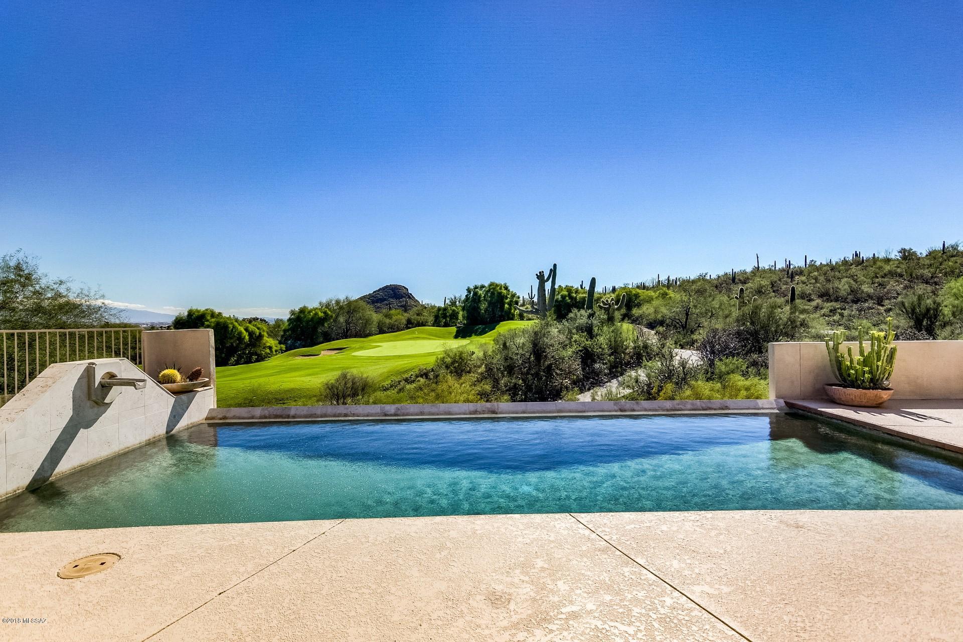 Elegant custom home offers unparalleled craftsmanship and exceptional amenities! This Santa Fe/Sonoran inspired design is truly remarkable inside and out! Features include pine cabinets, granite countertops, wine rack and custom windows that provide plenty of natural lighting! Spacious size bedrooms that offer plenty of room for sleep or study. Master Suite encompasses an incredible garden bathtub. The backyard embodies the pristine pool/spa-perfect for those hot summer days! STUNNING mountain views of Tucson! Also overlooks Starr Pass Golf Course. This home is a true oasis away from the hustle and bustle! Look no further! This is a true beauty in the heart of the AZ desert! Hiking Trails.