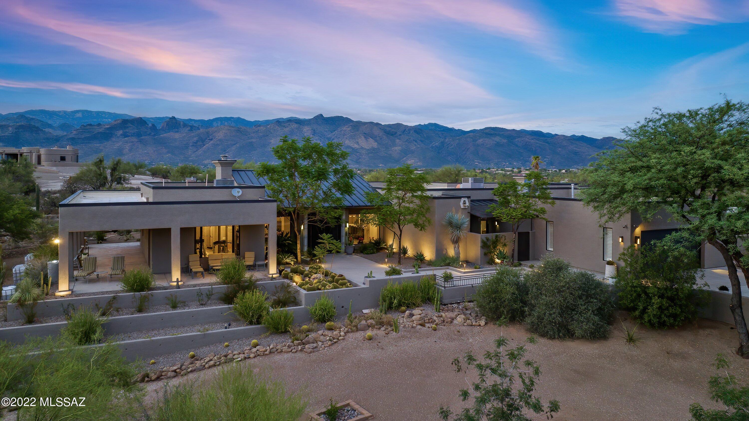 An Arizona masterpiece of modern and luxurious design on over 5 acres awaits you. Main house is approx 4000 s.f. 4 bed/3.5 bath, with an 1100 s.f. 2 bed/1 bath guest house. Gourmet kitchen with Wolf & Subzero appliances, 2 ovens, fireplace, quartz countertops and gorgeous cabinetry comes together timelessly. The sleek and comfortable living room with fireplace surrounded by picture windows brings in big views and sunsets.  The primary bedroom boasts amazing views w/a third fireplace and an enormous en suite bathroom with a walk-in cedar closet and more.  There's a separate heated/cooled studio surrounded by glass walls just off of the main bedroom - an inspiring area for an art studio, home office or exercise room. The spacious guest house comes furnished.