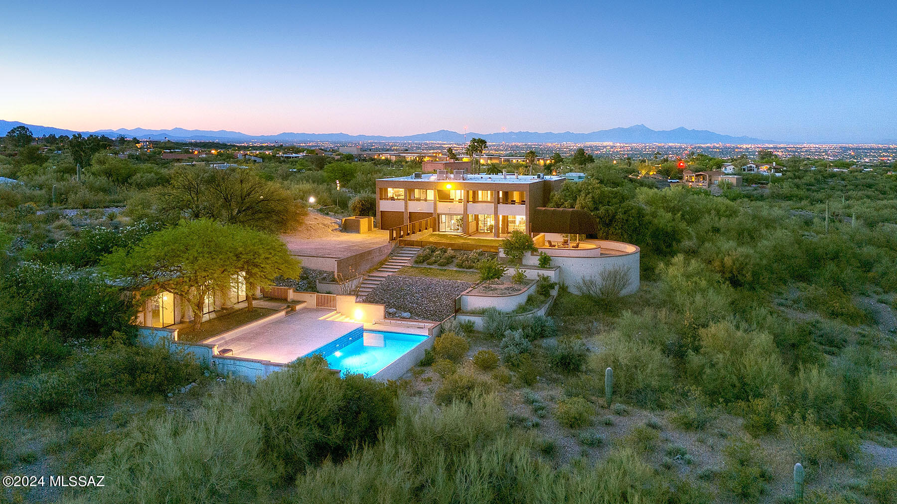 Stunning ''Post Modern'' style home, as described, designed and built by prominent Tucson architect Doug Seaver of Seaver Franks Architects, for himself and family.  Located on a prime 1.45 acre peninsula in the Catalina Foothills and adjacent to an approximately 40 acre restricted area of Pontatoc Canyon, this architectural masterpiece has unobstructed Catalina Mountain, desert, La Paloma Golf Course and Tucson city views.  The 4-bedroom all brown brick main house has 4,262 sq. ft. and the detached pool house/guest house has 881 sq. ft.  Designed with attention to correct north/south orientation and passive solar amenities, enter into the dining /living room with soaring 2-story ceiling, concrete overlay floors, fireplace, grand piano riser and city views.  The chef's kitchen/family room offers quartz counters, designer stainless steel appliances including professional gas range with heavy duty vent for high heat and wok cooking, Sub-Zero refrigerator, and family room with fireplace and built-ins.  Gracious primary suite offers steam shower, soaking tub, dual walk-in closets, adjacent den/office, and outdoor balcony for morning and evening mountain viewing.  Rear grassed yard features canopied dining area, pool, views in every direction and a variety of fruit trees including fig, Meyer lemon, Fuji apple, apricot, peach, orange, Mexican lime and pomelo. The HOA offers trash collection, clubhouse, pickle ball and tennis court and pool.  See to appreciate this rare Tucson, architecturally significant home.