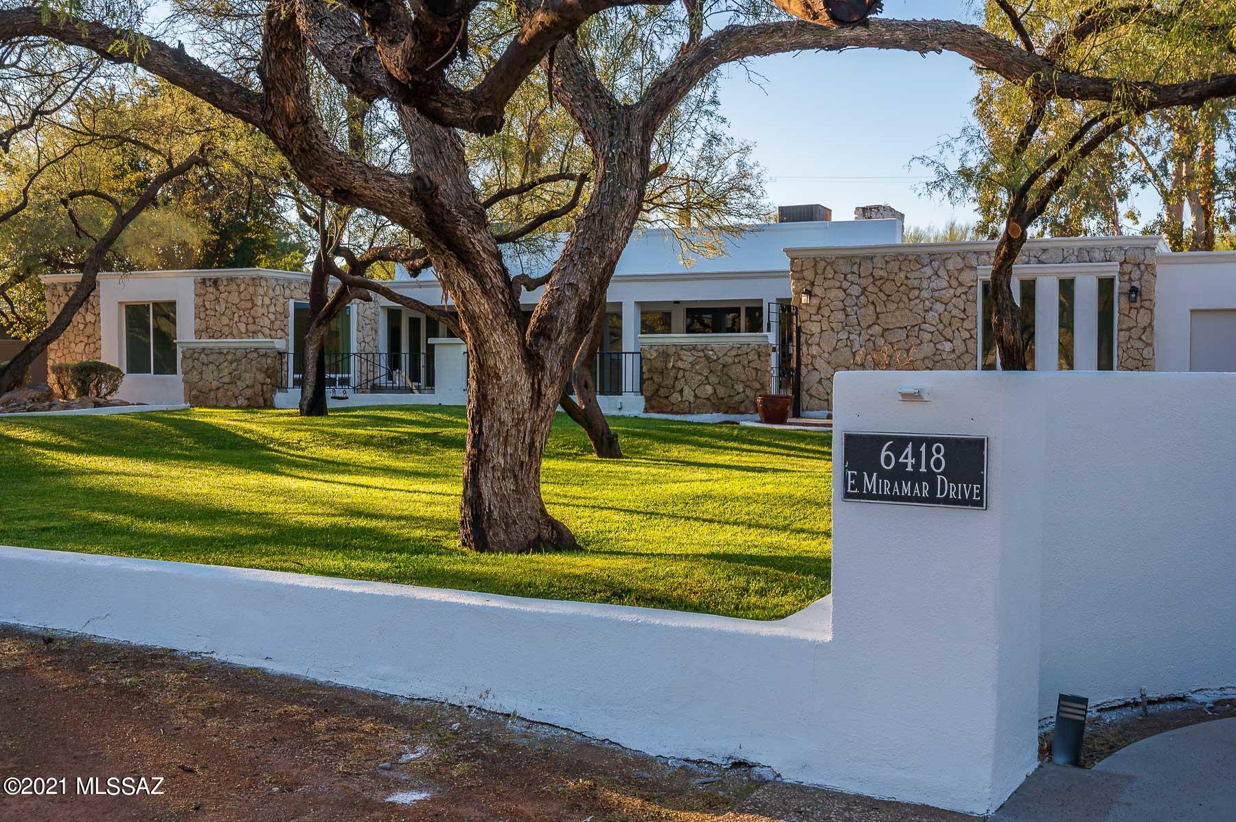 Architecturally significant home designed by famed architect, Ann Rysdale, in prestigious Tucson Country Club.  You will love the high ceilings, large windows with amazing natural light, clean lines and unique touches that note the simplicity of an era gone by.  Living room features wall of windows and doors that open to front courtyard and peek of mountain views, plus a sunken area by fireplace and built in library.  Gorgeous, well-appointed kitchen with Quartz countertops opens to oversized Dining Room.  Family Room features built in cabinetry and wood clad ceilings.  Generous owner's suite has a spacious private bath, oversized shower, walk-in closet and access to private side patio area.  Updated mechanicals, new flooring, lighting, fixtures, window and doors throughout.   Outdoor ... living and easy entertaining is found here, home is set well off the street with 4 garage parking, ample driveway for many guests.  Mature landscape all around, with grassy mesquite area in front facing street, large covered patio and several seating areas in private backyard.  Guard-gated Tucson Country Club is located within minutes of "The Loop" with easy access to golf, hiking, restaurants, shopping and most everything Tucson!