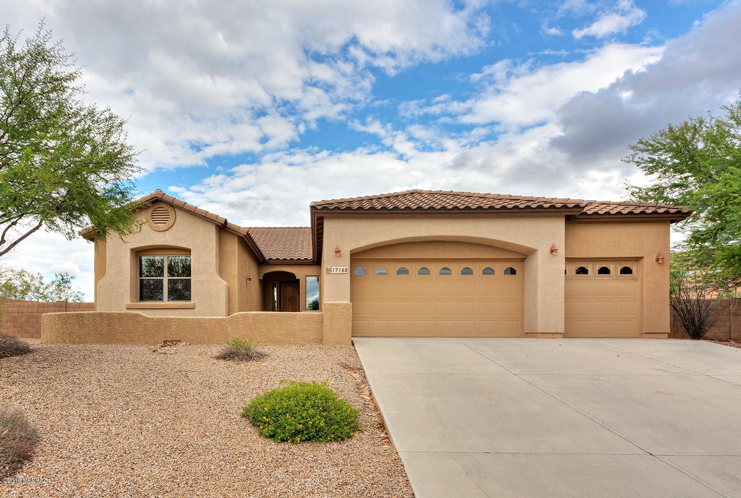 Beautifully well maintained 3BD contemporary home with den on over 1/3 acre in Vail.  Open floor plan, tile floors throughout.  Spacious kitchen with breakfast bar, dual sinks & SS appliances. Split bedroom plan, walk in closet in master bdrm, dual sinks in master bath. Lots of storage.  3 car garage. Large back patio area for enjoying panoramic desert views. Home backs up to arroyo with no neighbors behind. Community pool. Easy access to main roads.  Come and take a look today!