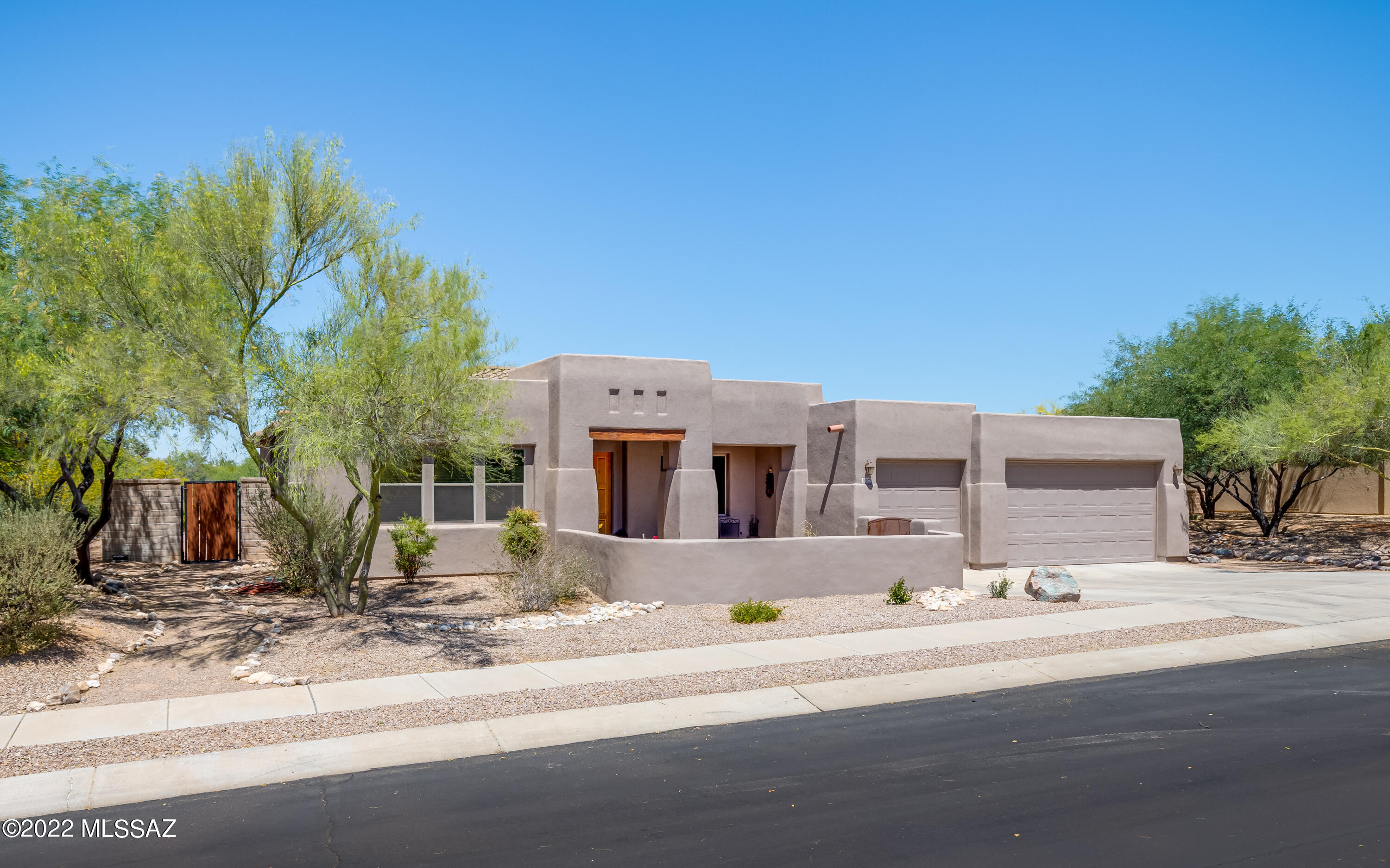 Luxurious semi-custom 4 bed 3.5 bath, 2868 sqft home on 1.01 acres w/ 3-car garage & open views in gated community w/ natural space between houses. Walled-in courtyard enhances multiple mountain views. Spacious open floor plan w/ picture windows overlooking new resort-style pool & hot tub w/ travertine & luxury stone surrounds, fully smart-app controls & multiple LED color lighting.  Split floorplan w/ extra living room/office & guest qtrs are fully updated w/ updated brushed nickel hardware throughout. Spacious master bedroom & bathroom w/ walk-in shower, jetted soaking tub, walk-in closet. Kitchen boasts new stainless-steel appliances, granite countertops & wrap around rich maple cabinetry with a praline glaze. See attached Features List for more!