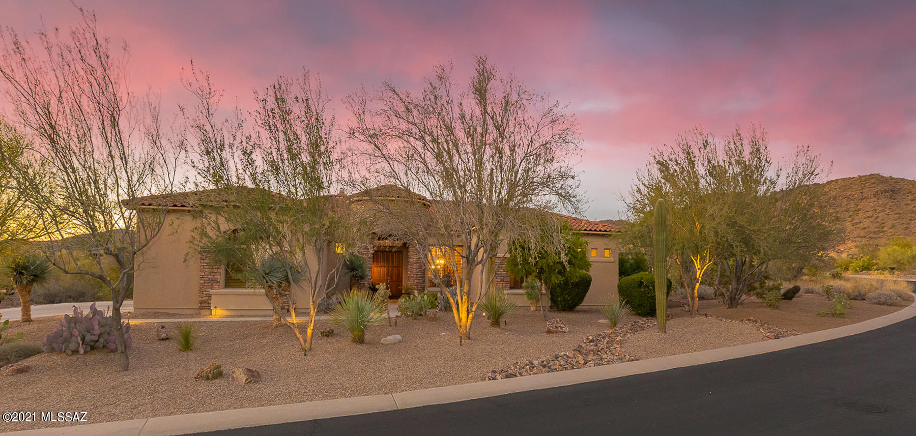 Striking 3BD/3.5BA +Den (3,811sf) semi-custom home on a private 1 + acre lot in gated Dos Lagos at Dove Mountain boasts architectural detail and spectacular Tortolita mountain views. Welcoming stone pillar entry flows to a formal dining room w/ tray ceiling and living room w/ stacked stone fireplace. Adjoining Great room features a central chef's kitchen hosting dual breakfast bars, nook w/ bay window, island, granite countertops & stainless appliances. Elegant Master suite w/ bay window and his/hers closets hosts a luxury bath w/ dual vanities, soaking tub & tiled walk-in shower. En suite baths in all bedrooms. Rich wood flooring in office/den. Resort-style yard boasts a heated pool, spa w/waterfall, raised fireplace patio and putting green. Minutes to Gallery Golf Club and Ritz-Carlton.